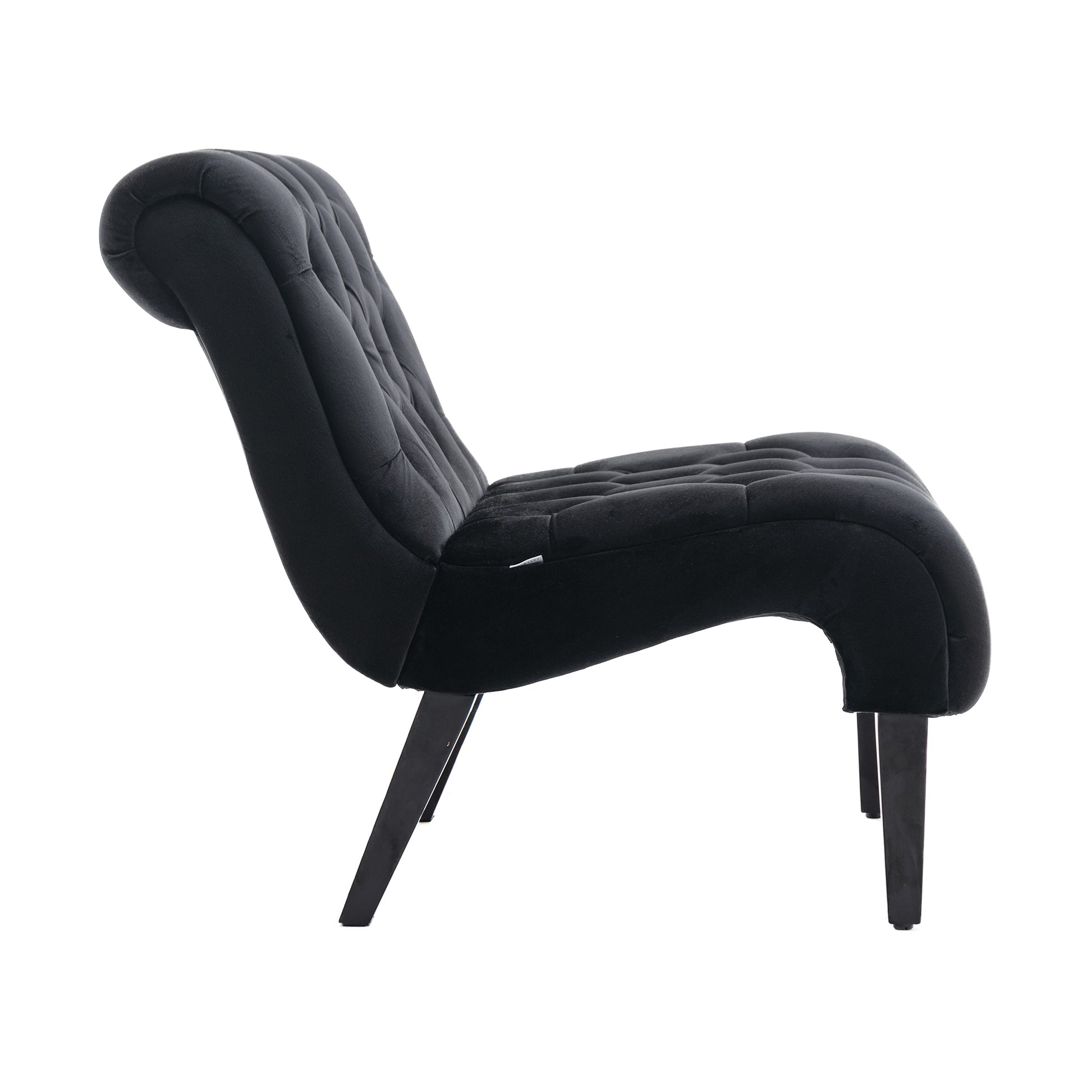 Black velvet accent chair with deep button tufting and curved silhouette