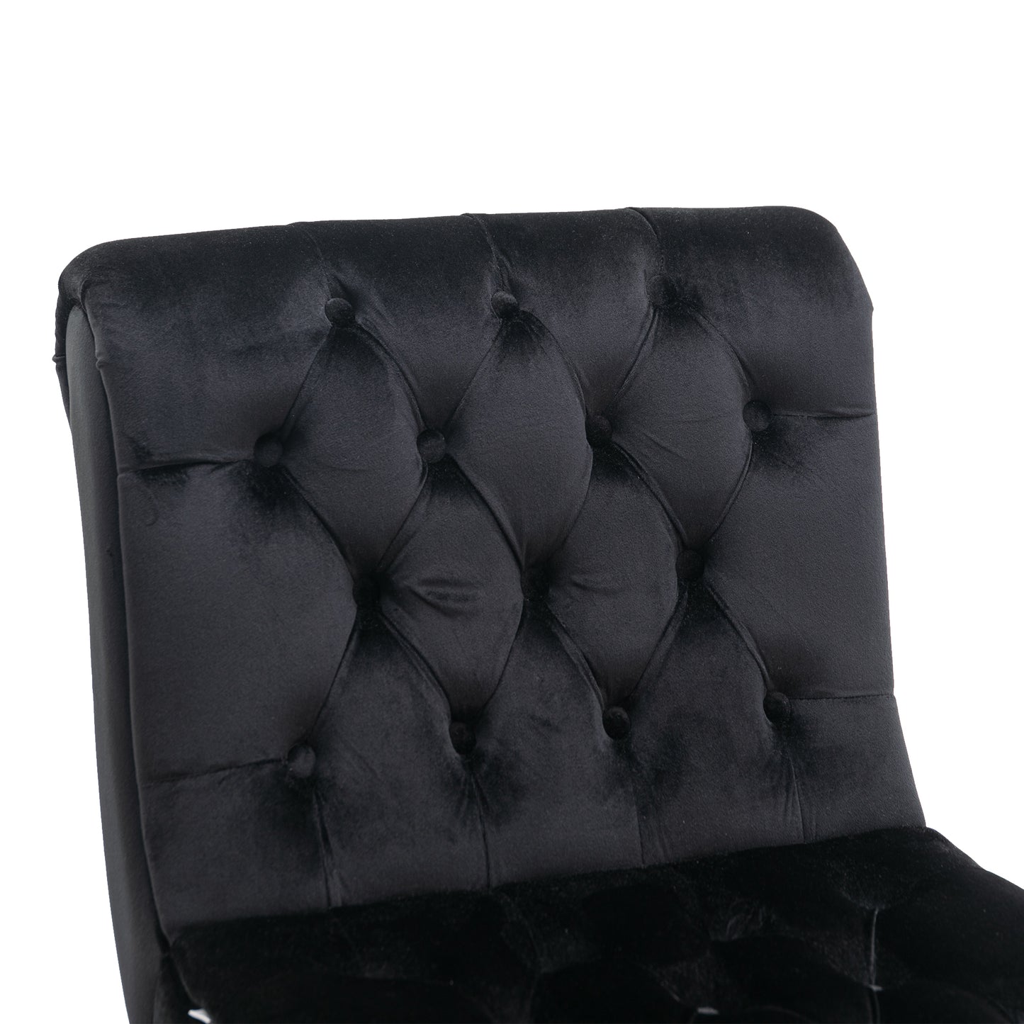 Close up of tufted black velvet armchair back