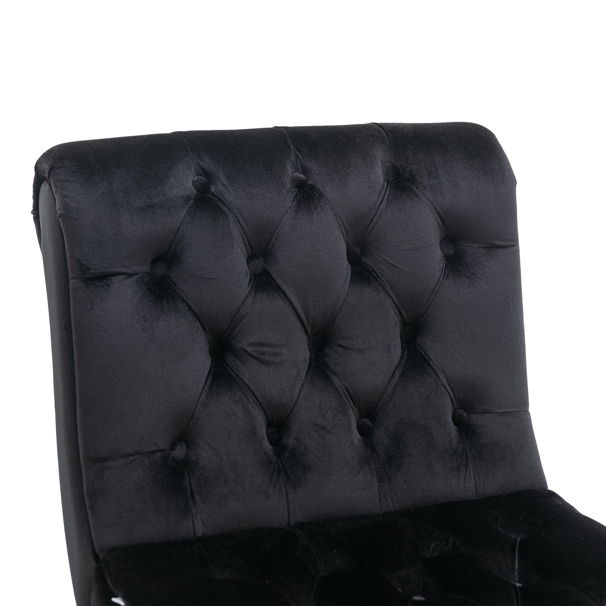 Close up of tufted black velvet armchair back