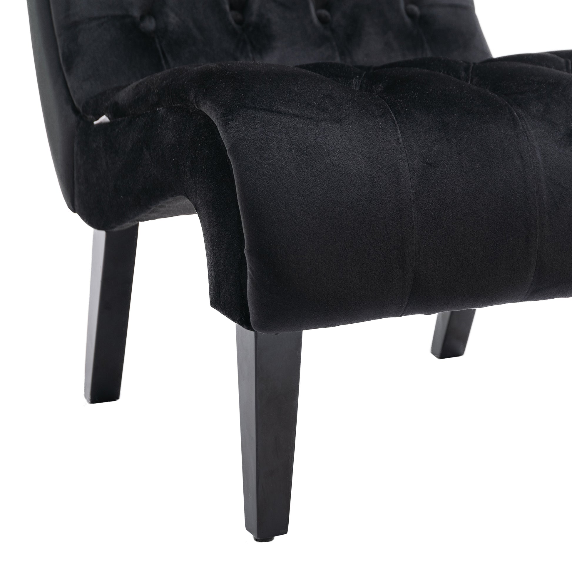 Black velvet accent chair with button tufting and sturdy wooden legs