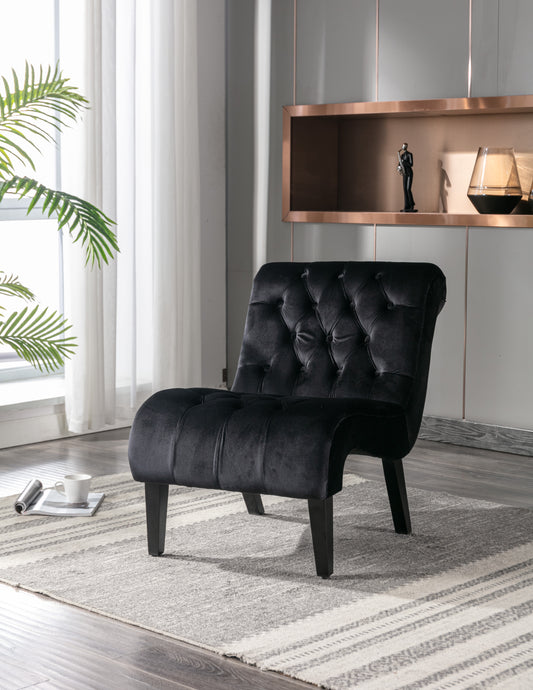 Black velvet accent chair with deep button tufting and dark wood legs