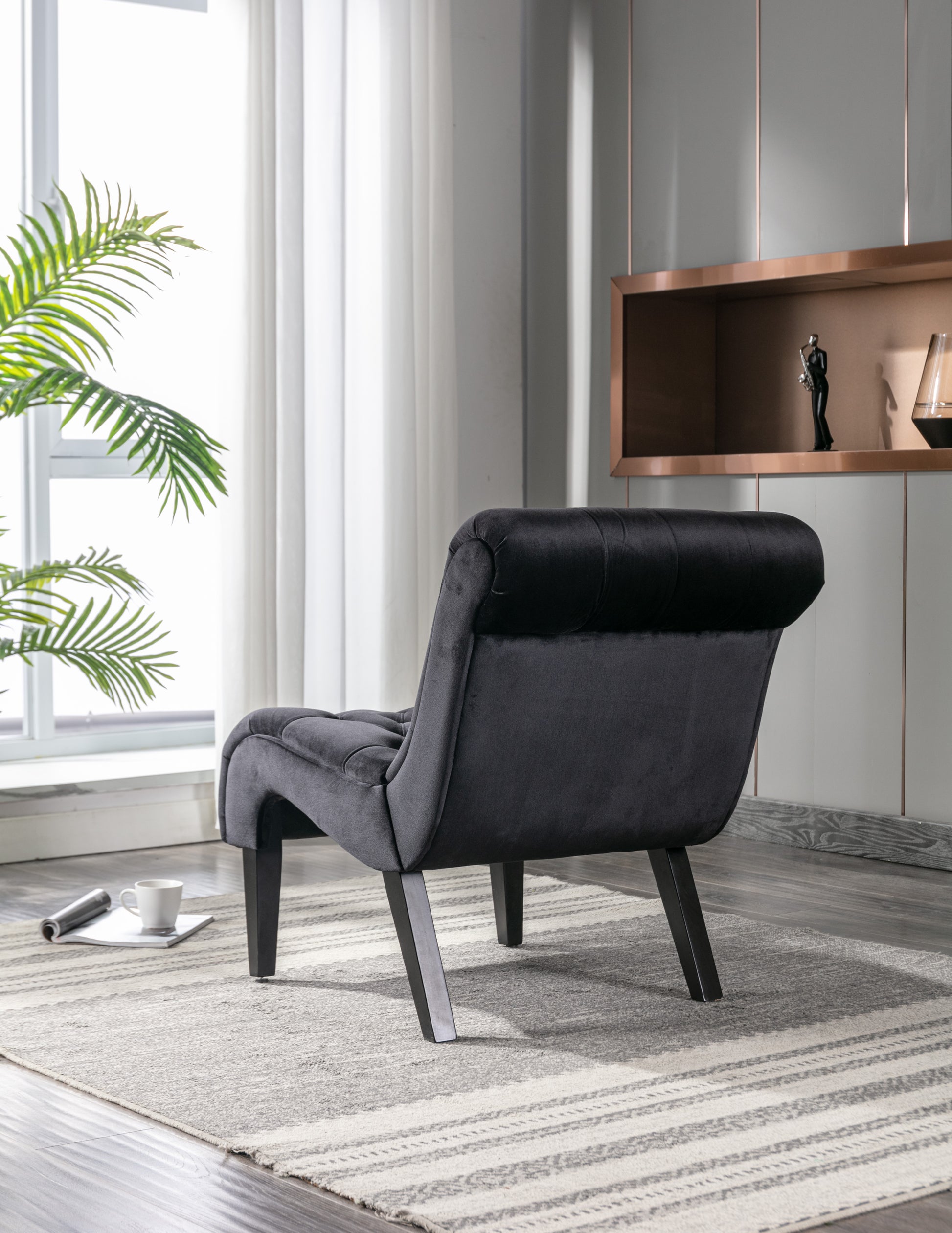 Tufted black velvet accent chair with wooden legs perfect for modern living rooms