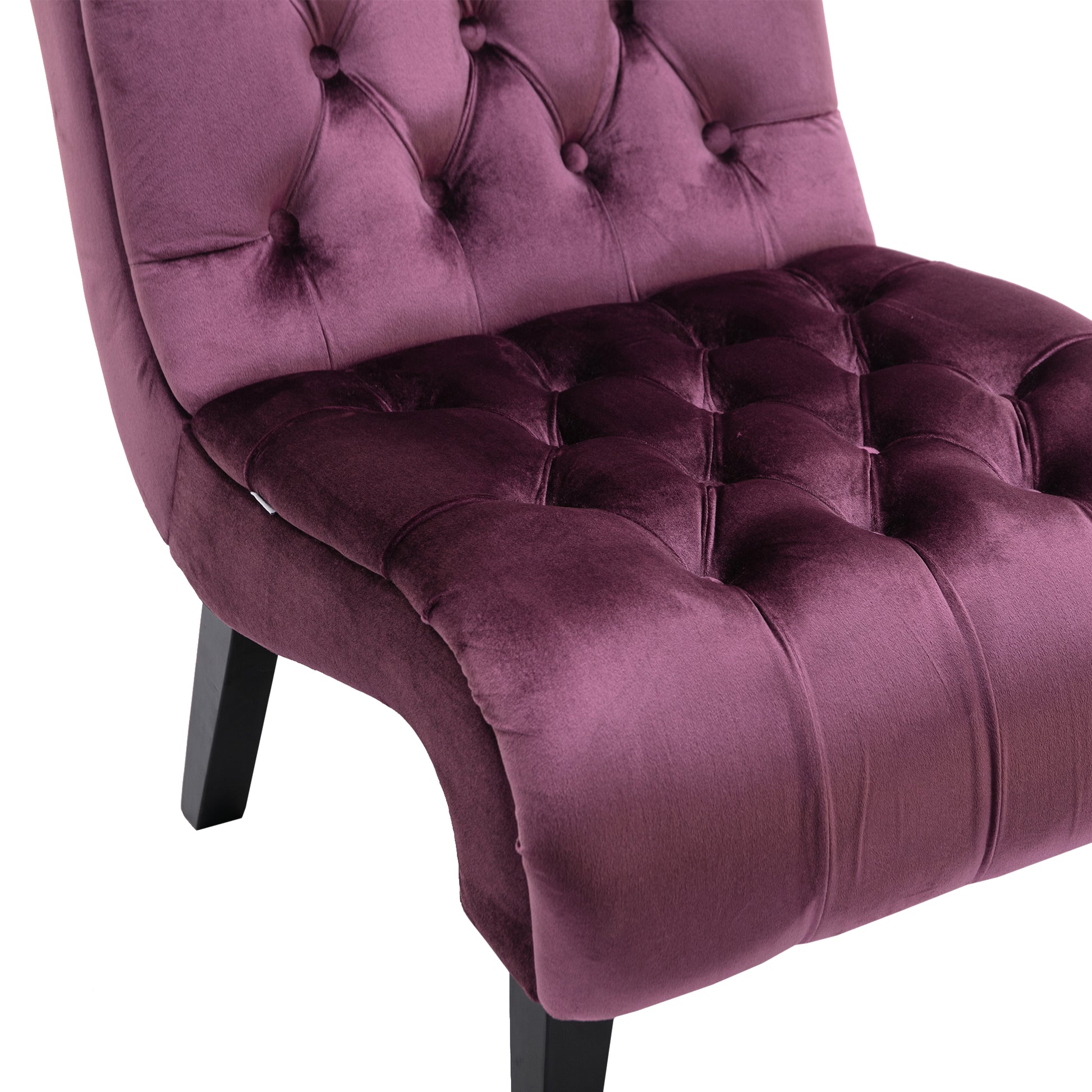 Plush plum velvet accent chair with deep button tufting and black tapered legs