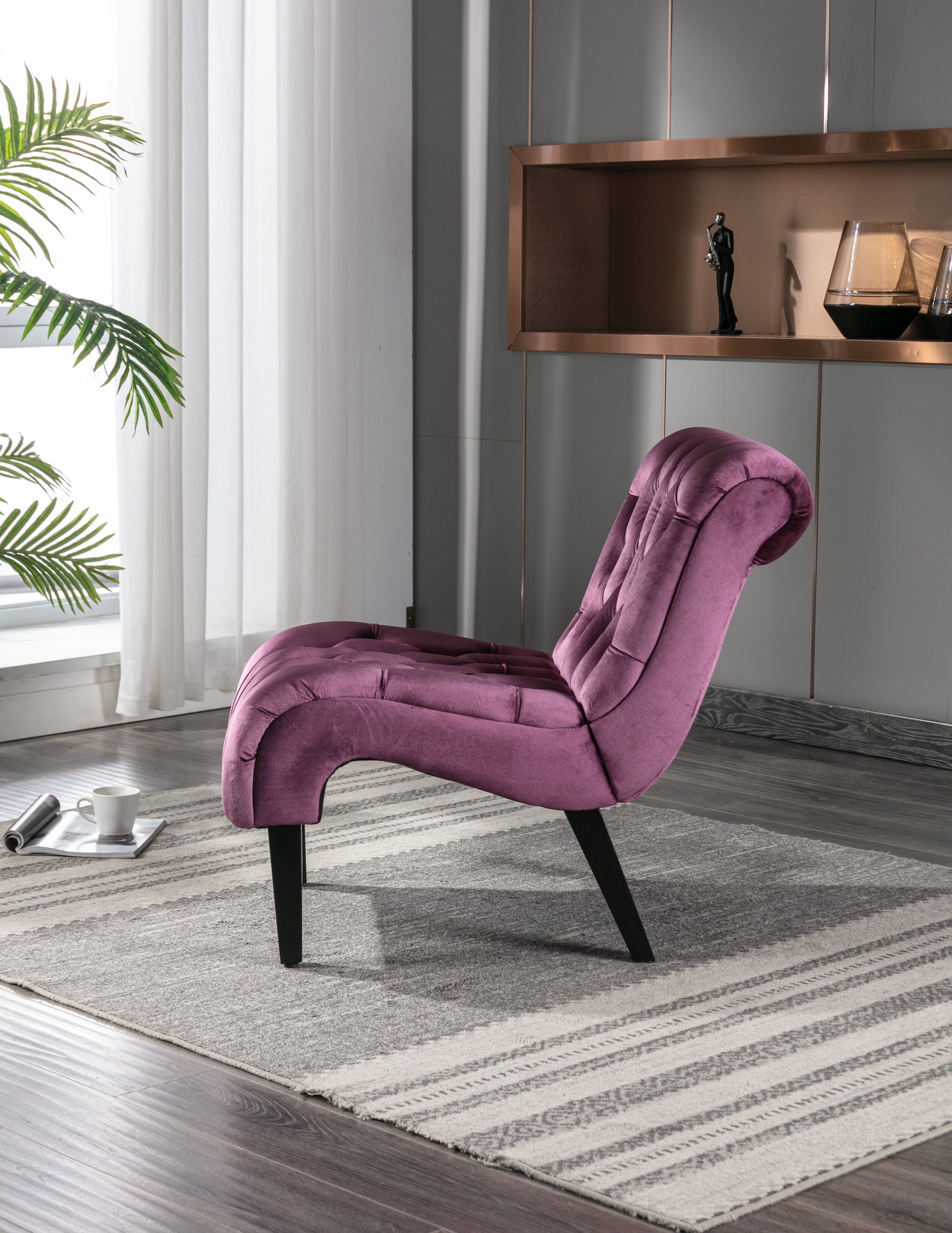 Plush velvet accent chair in a deep magenta with button tufting and curved back support