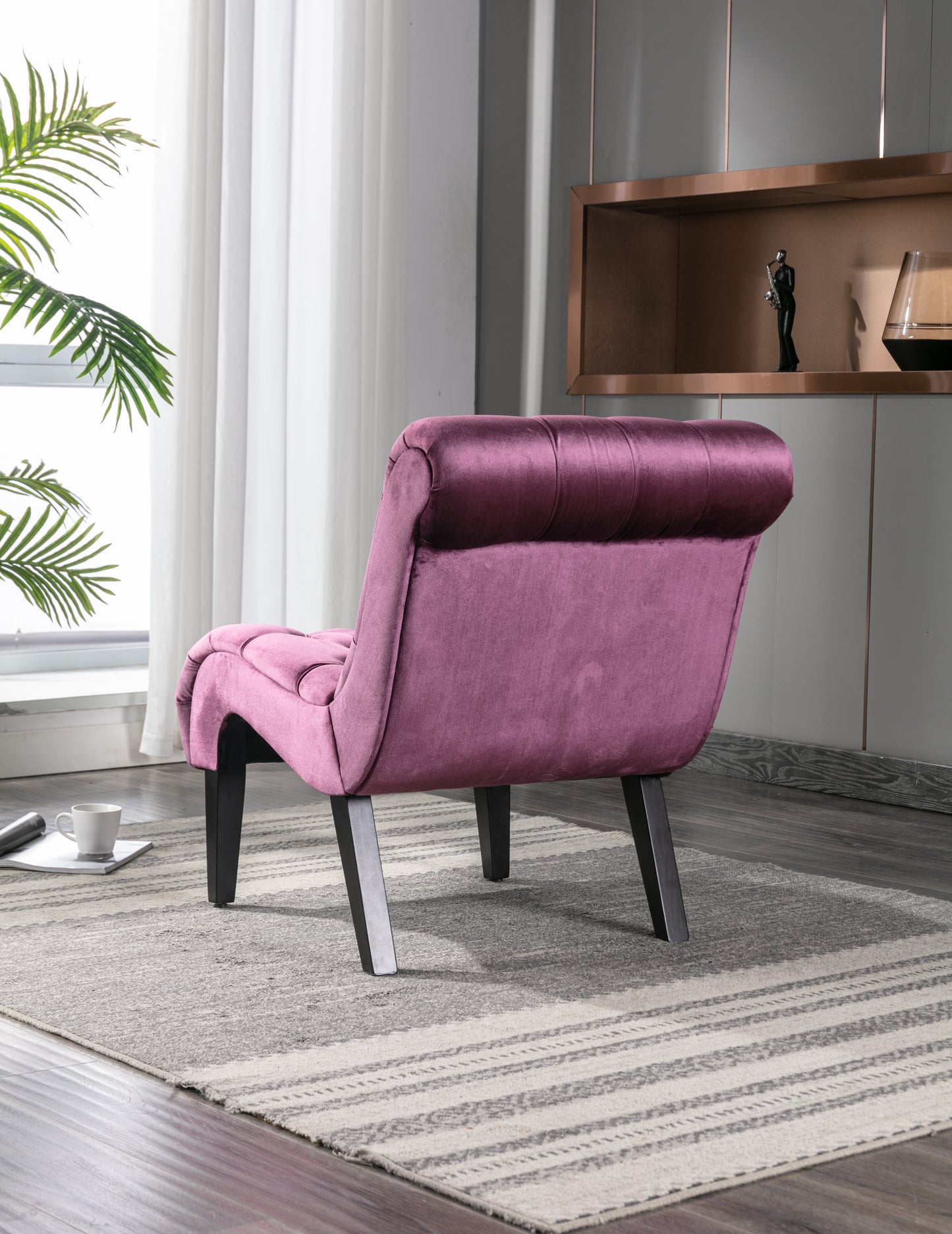 Plush velvet accent chair in dusty rose with deep button tufting and dark wooden legs