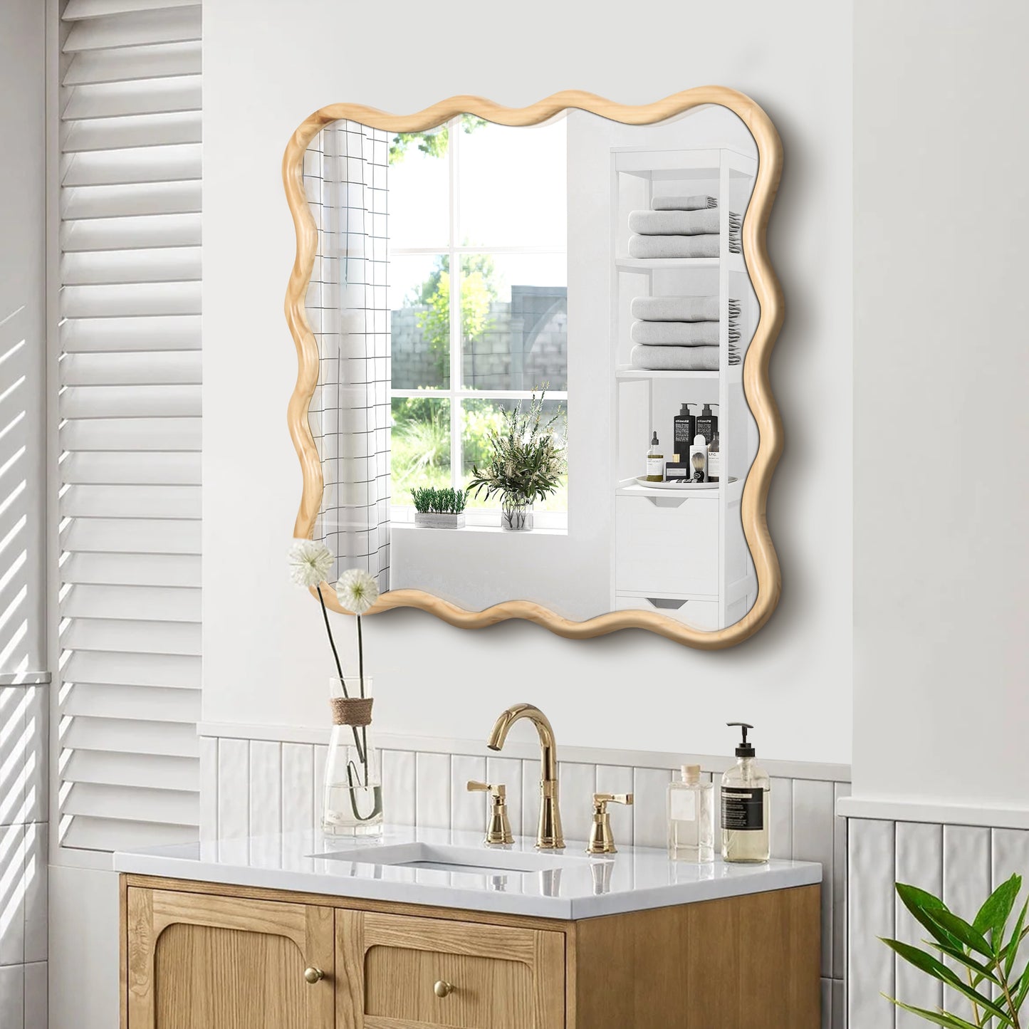 Wavy natural wood framed bathroom mirror with modern vanity and gold fixtures
