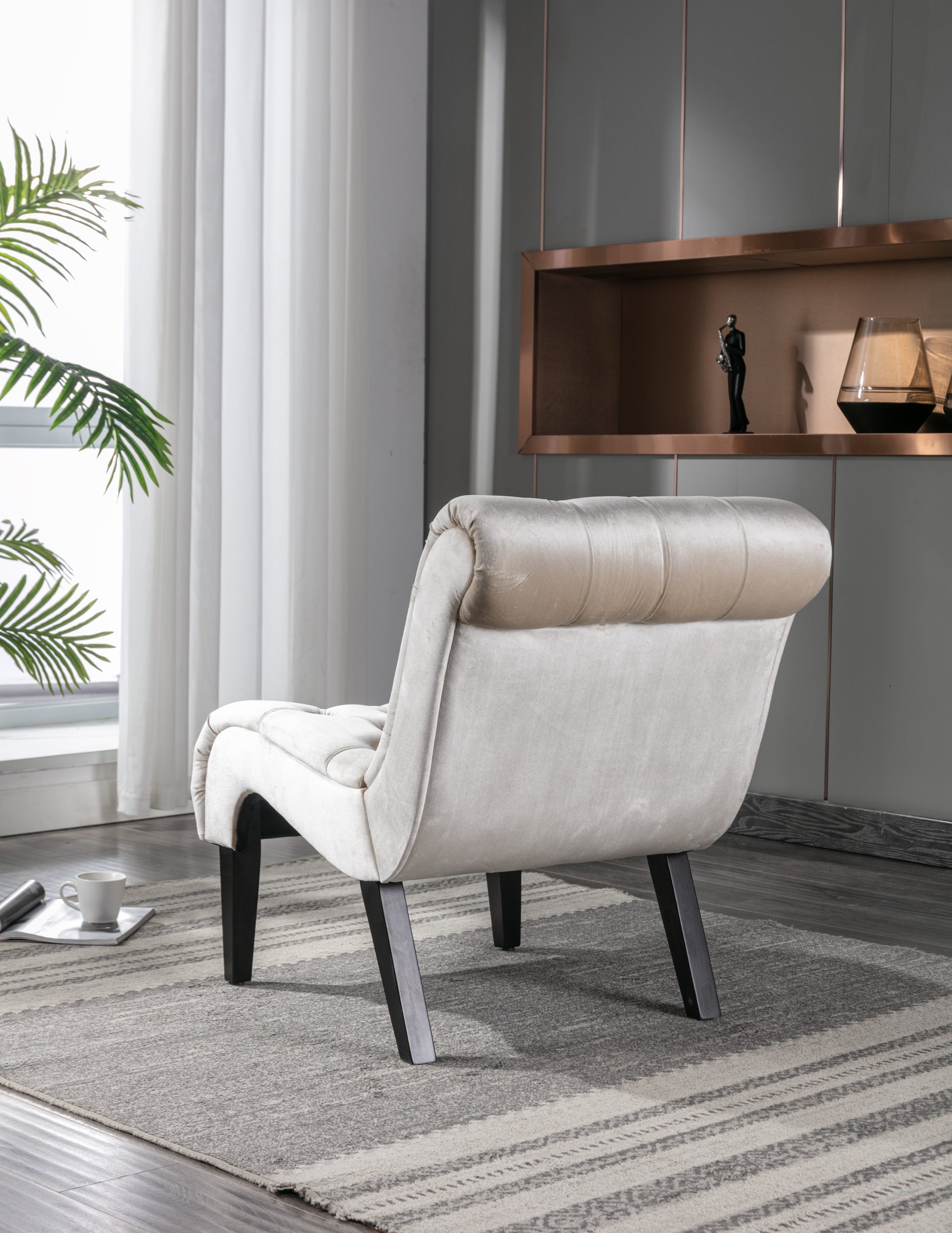 Champagne velvet accent chair with tufted back and dark wood legs