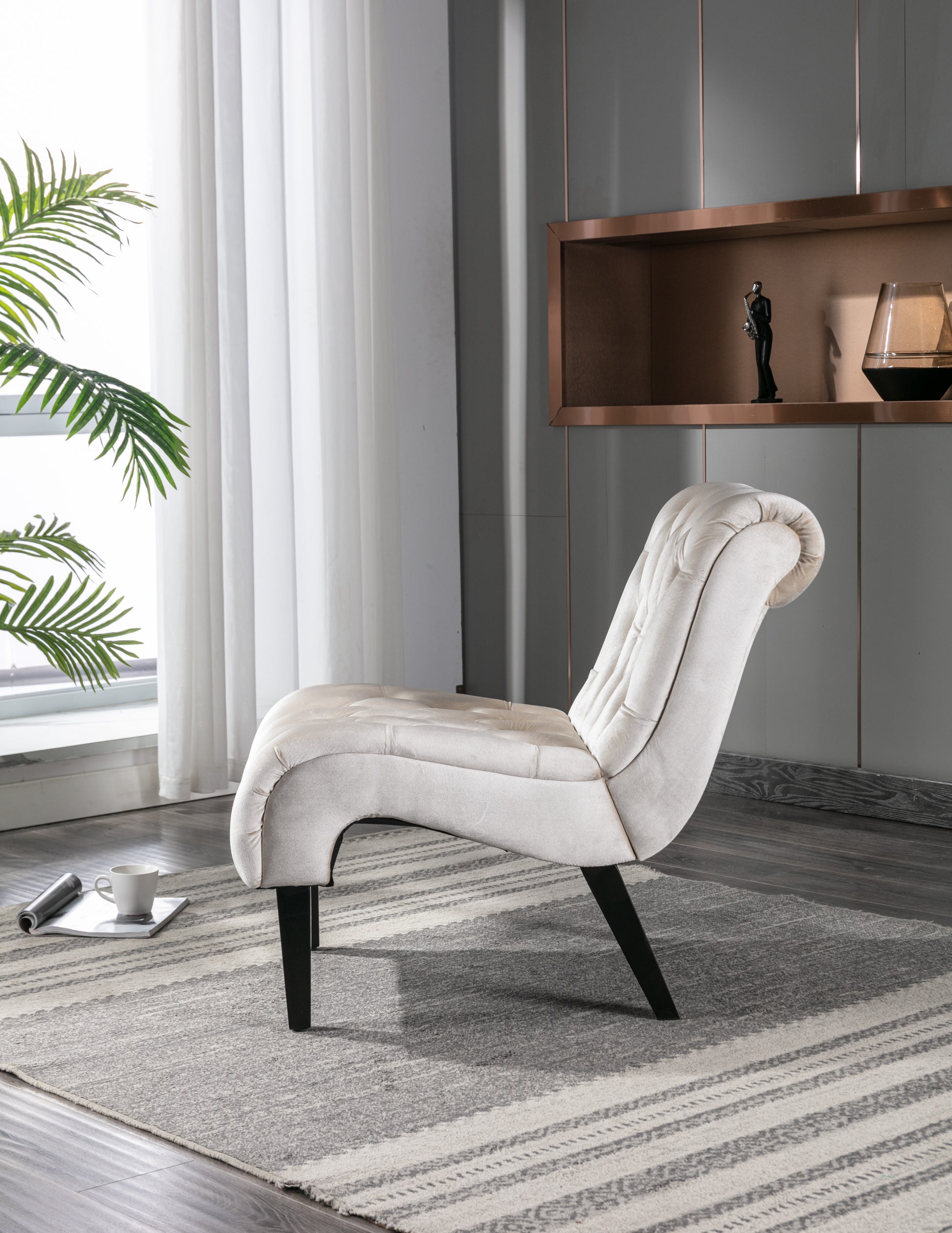 Cream velvet accent chair with tufted back and sculptural seat