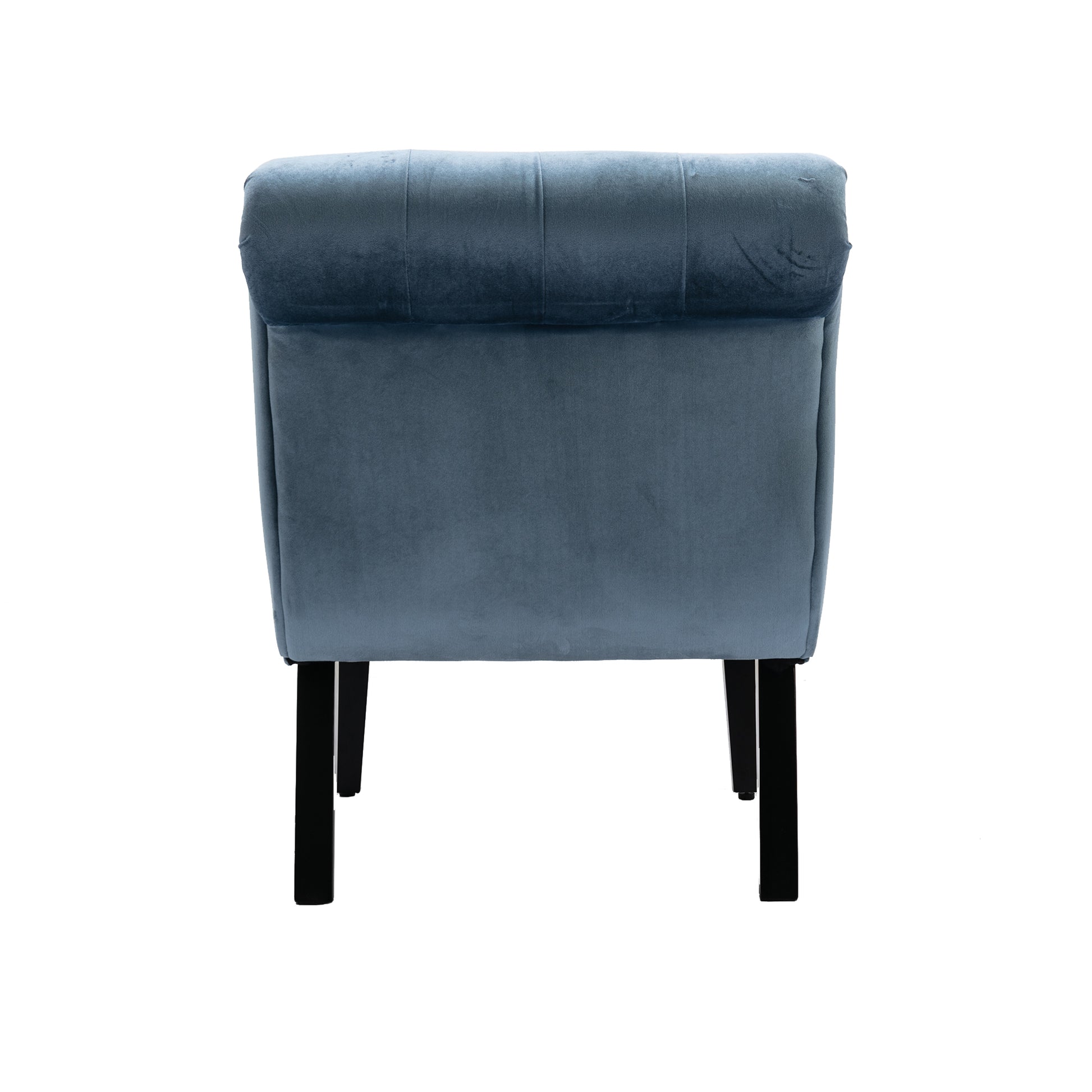 Back view of a tufted grey velvet armchair with black wooden legs