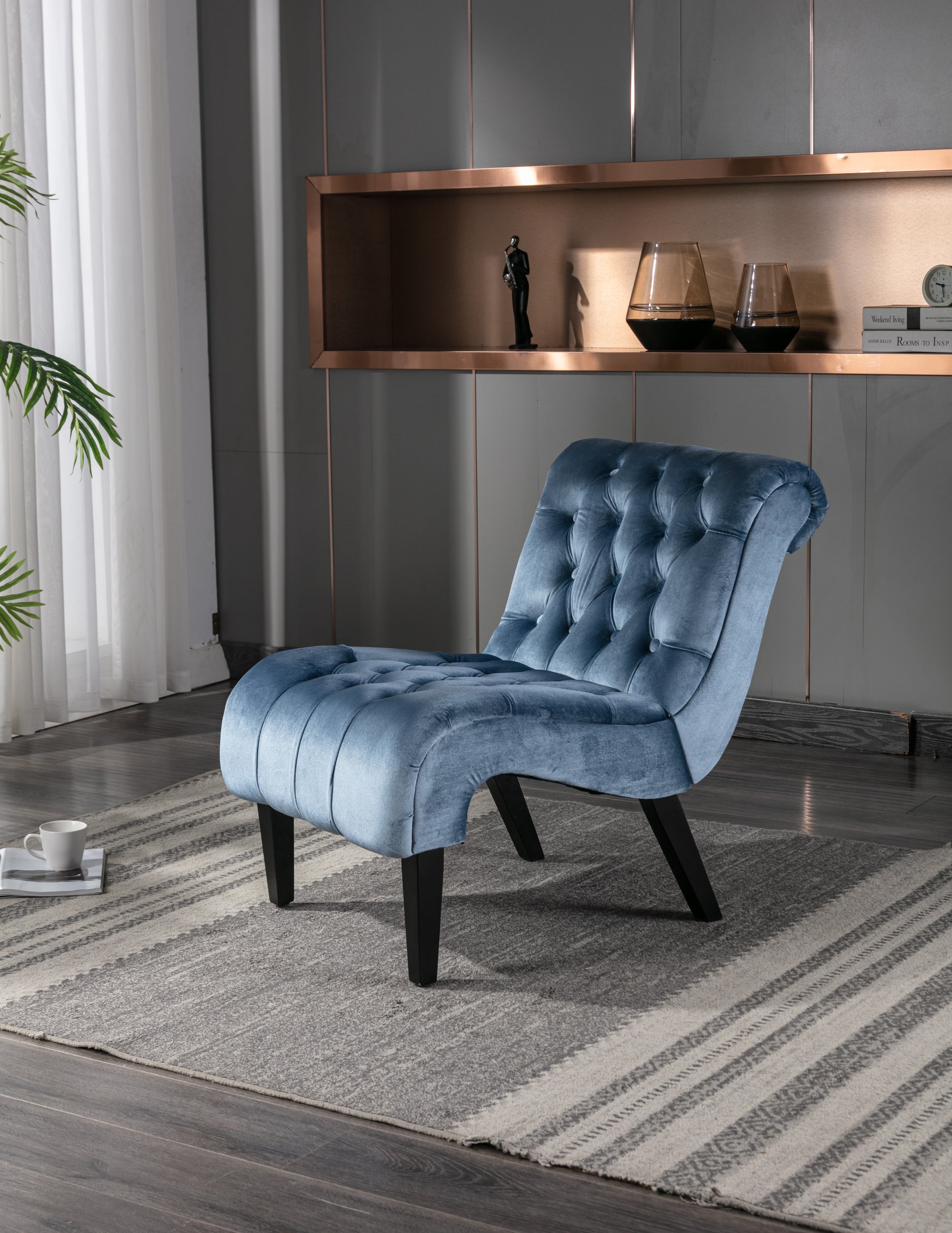 Tufted blue velvet accent chair with dark wood legs perfect for modern living rooms