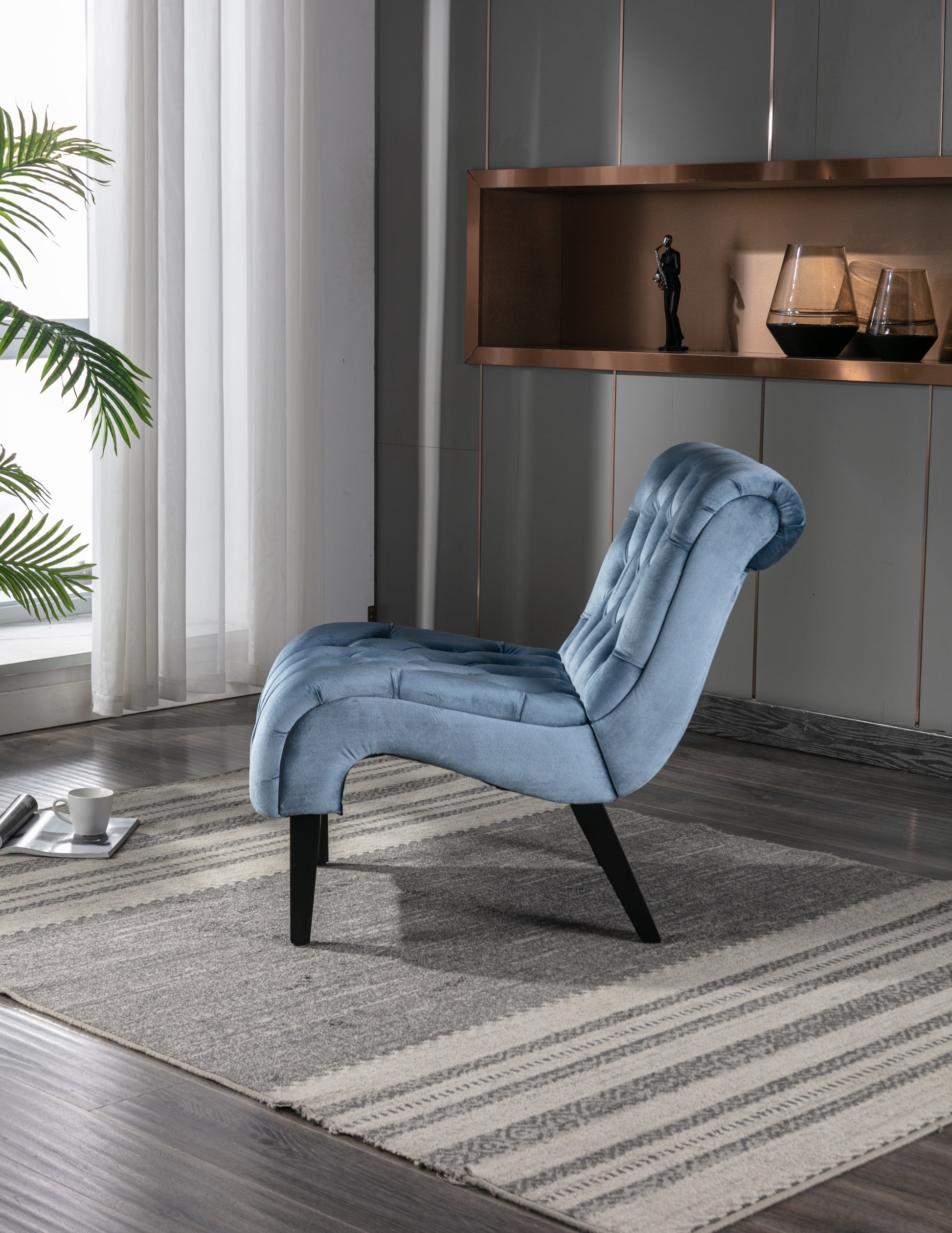 Plush blue velvet accent chair with tufted back and elegant curves