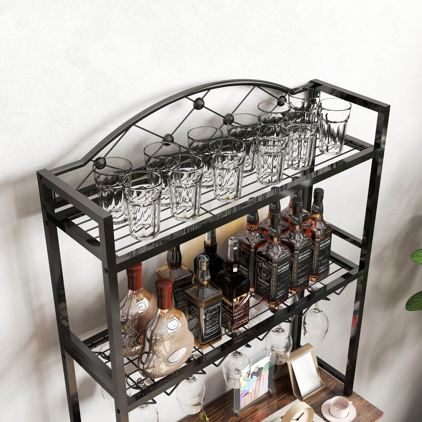 Black metal bar cart with glasses and whiskey bottles on shelves