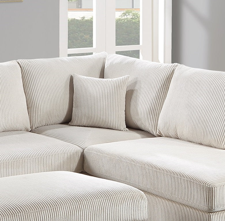 Cream corduroy sectional sofa with plush throw pillows for a cozy living room