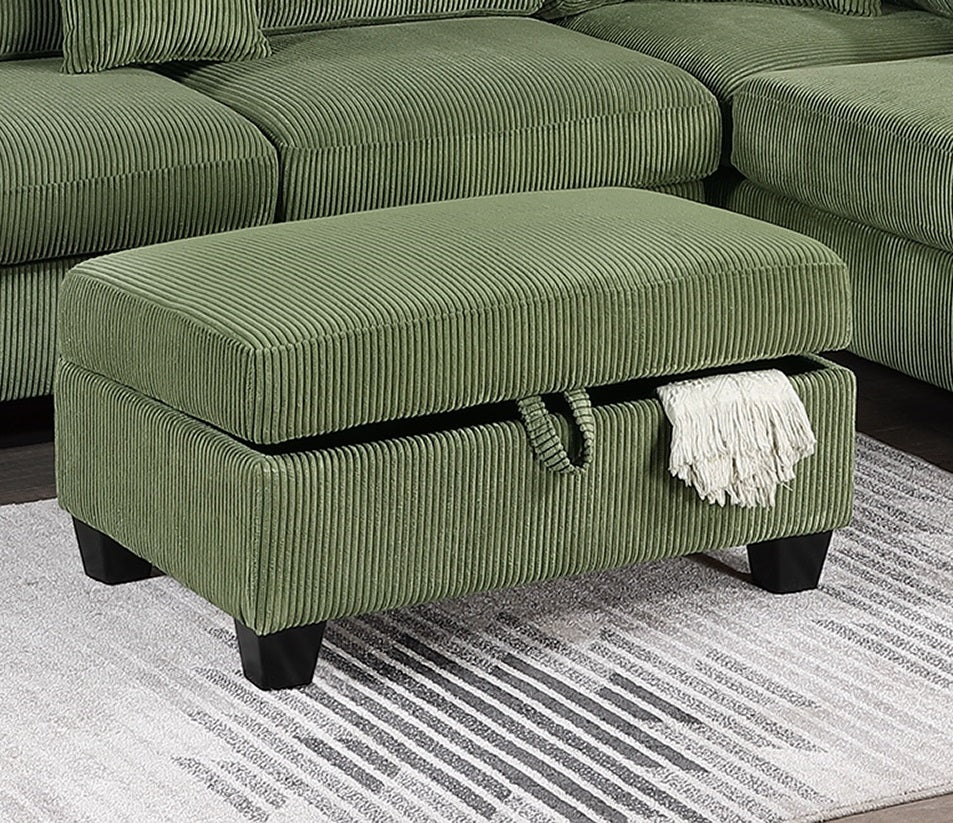 Green corduroy storage ottoman with black legs accenting a sectional sofa