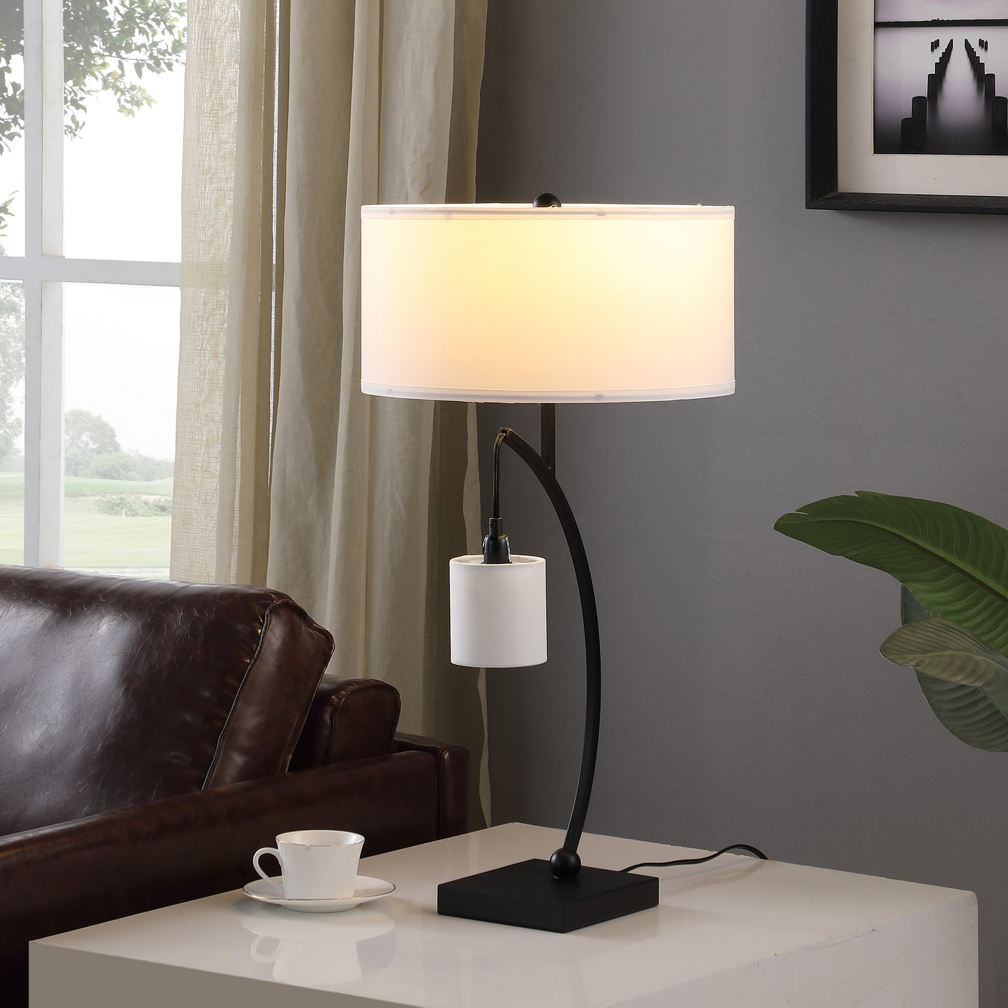 Modern black metal desk lamp with a white drum shade and accent light