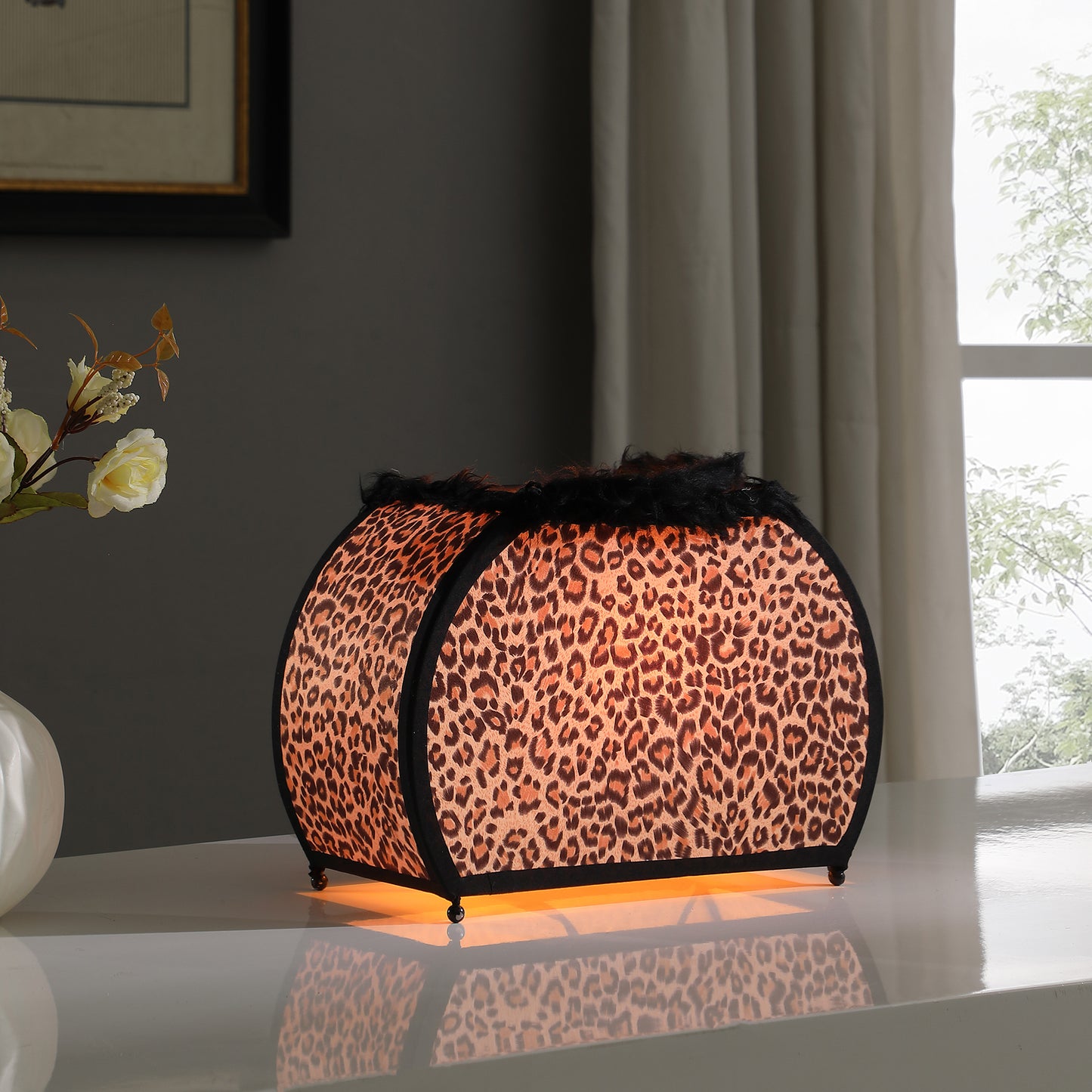 Leopard print fabric table lamp with black trim and faux fur accent