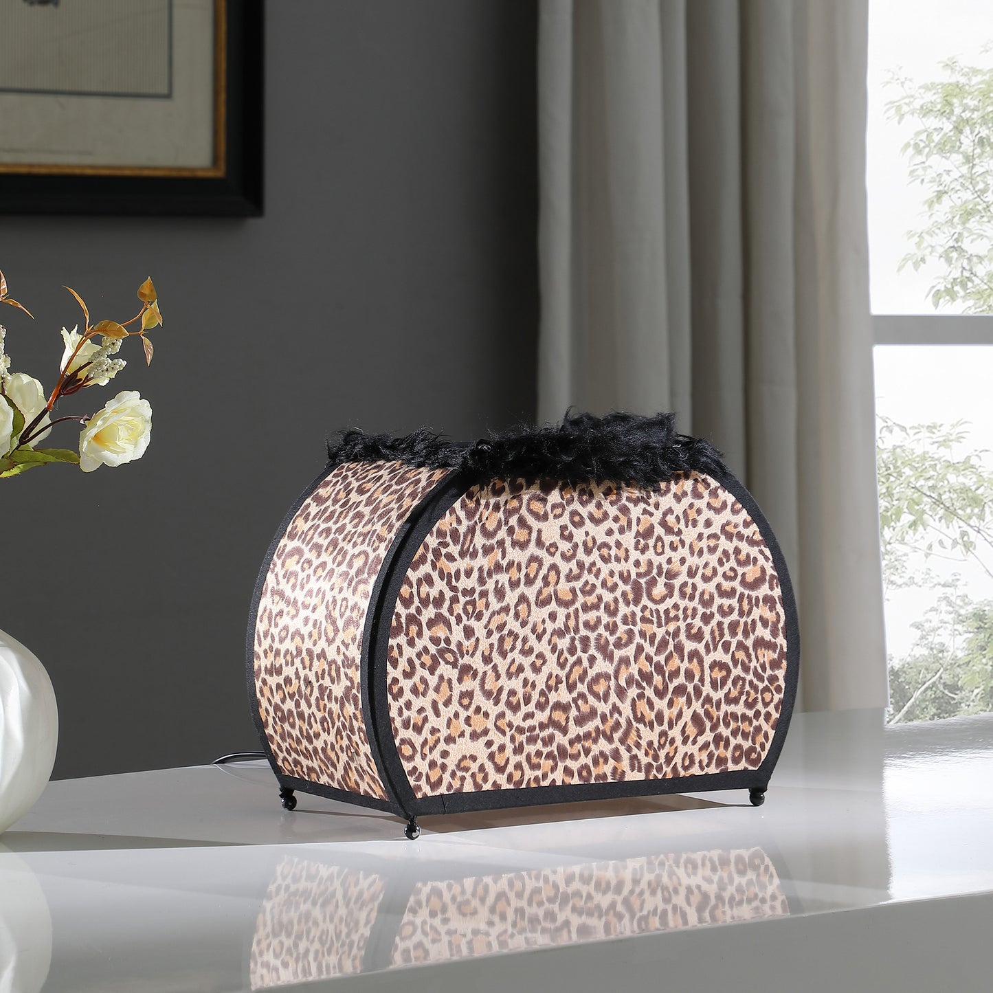 Leopard print bedside lamp with black trim and fluffy top edge