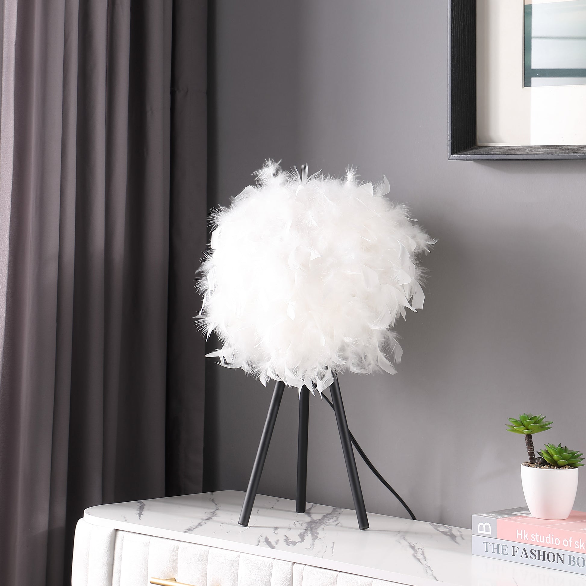 Fluffy white feather table lamp with black tripod base