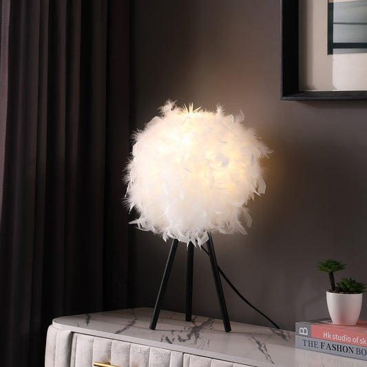 White feather table lamp with black tripod base ambient light