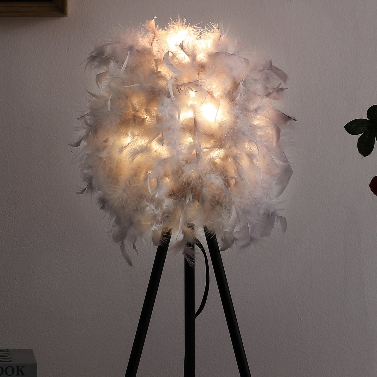 Soft white feather floor lamp with black tripod base ambient light