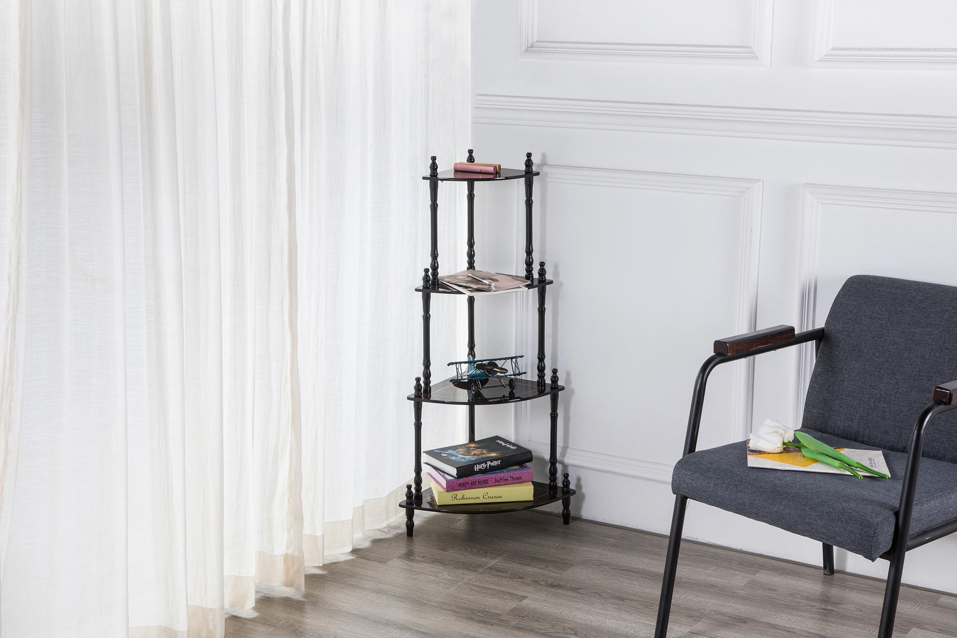 Black fourtier corner shelf with decorative finials and glass surfaces