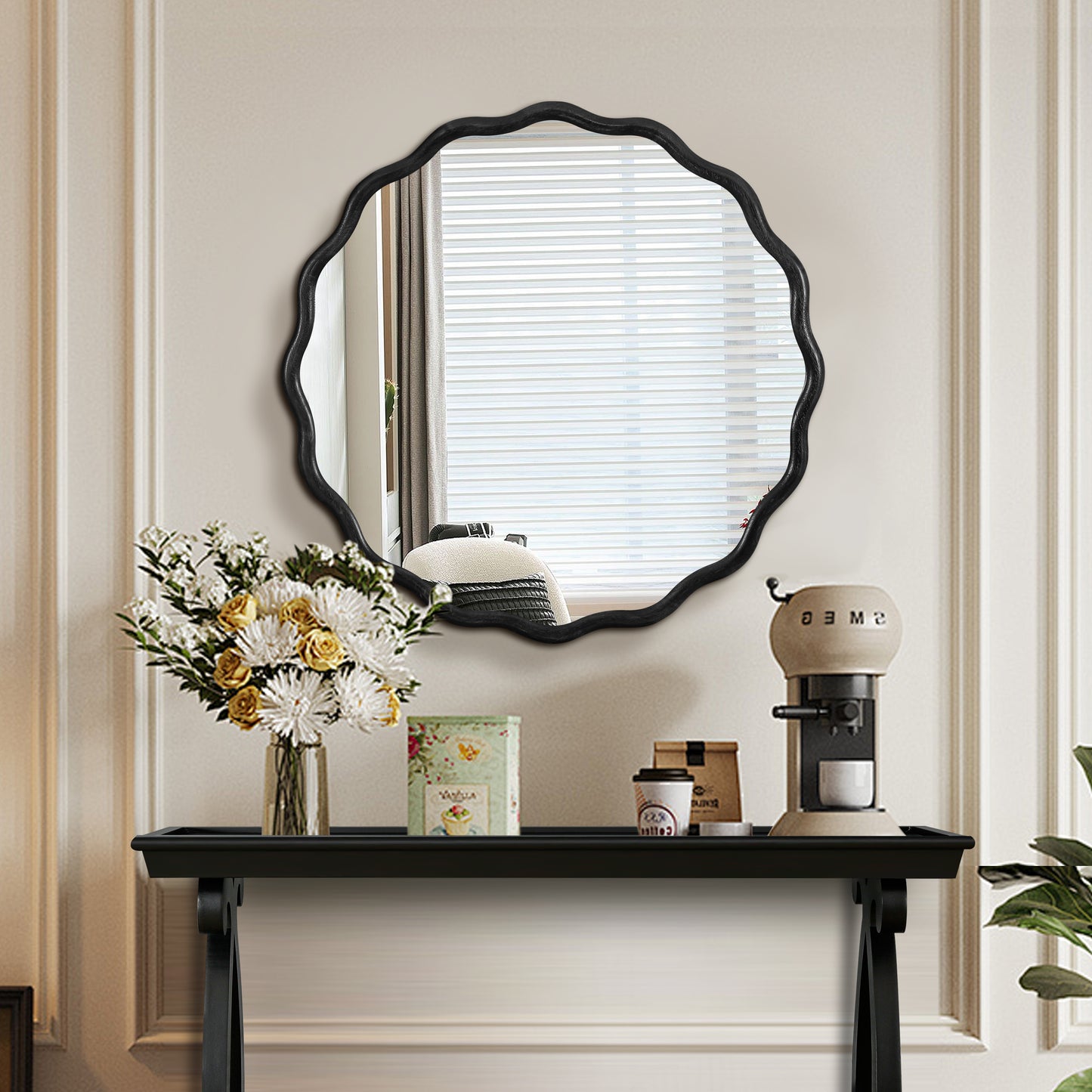 Ornate black scallopedge mirror for entryway decoration reflecting a bright window