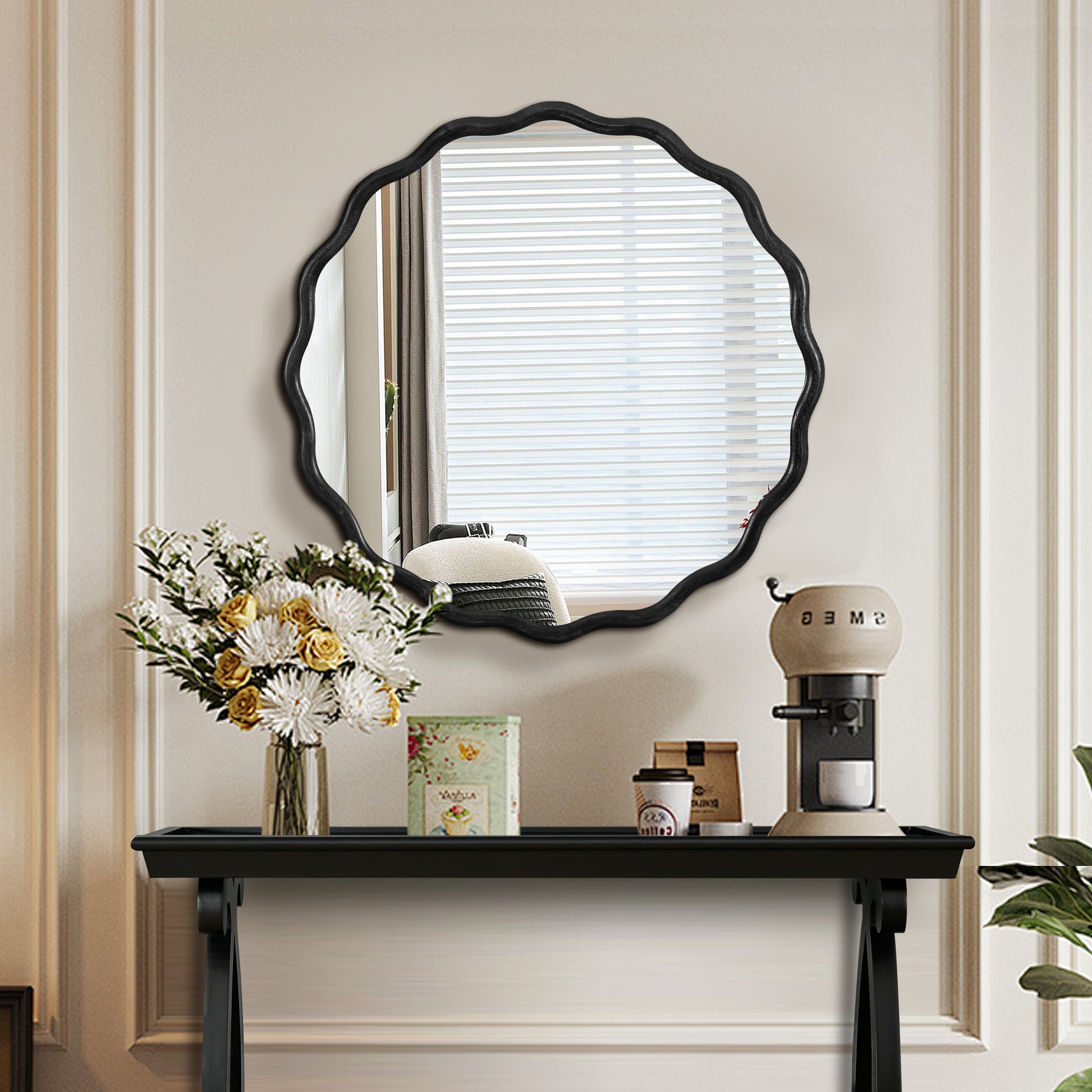 Ornate black scallopedge mirror for entryway decoration reflecting a bright window