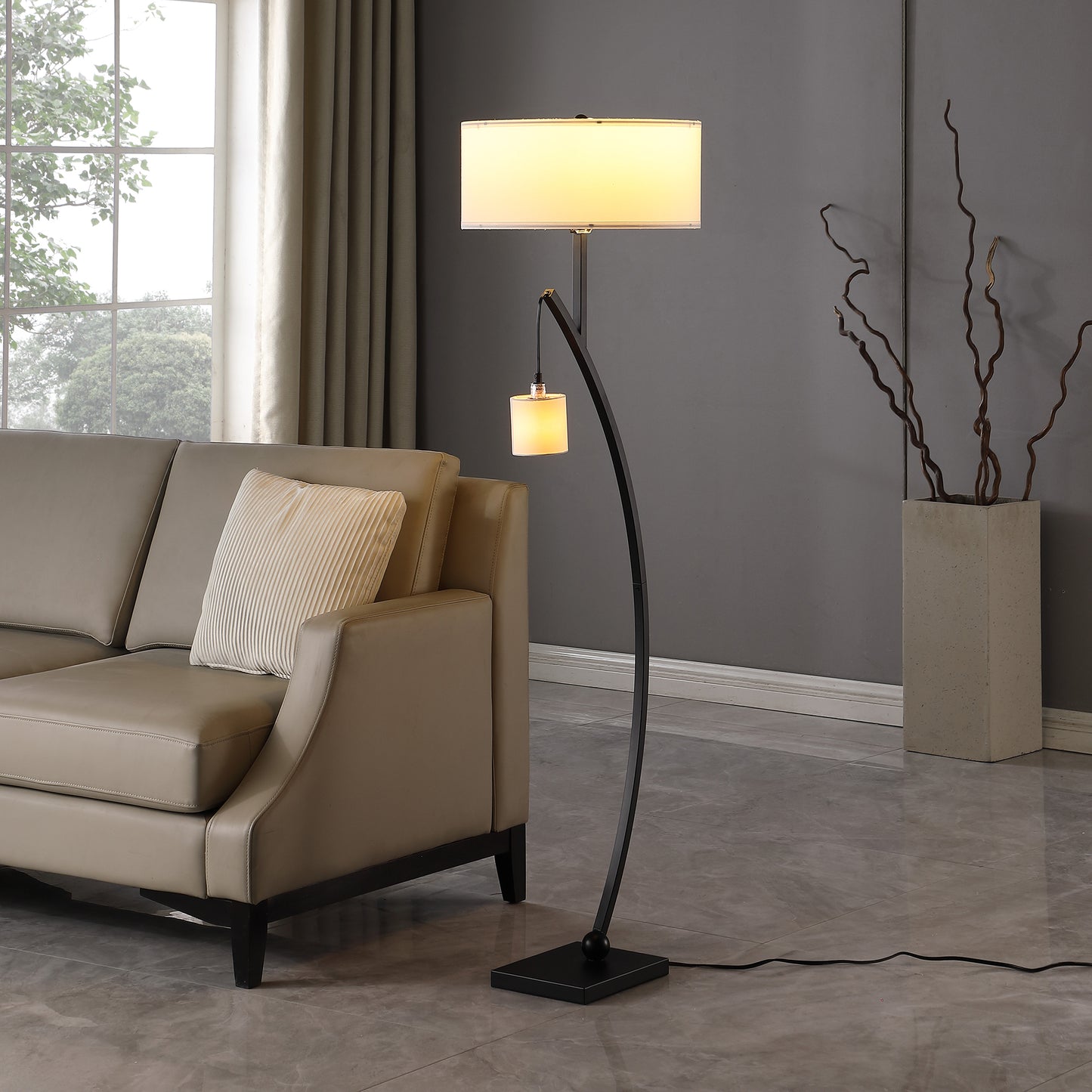 Modern black arc floor lamp with a rectangular cream shade illuminating a contemporary living room setting