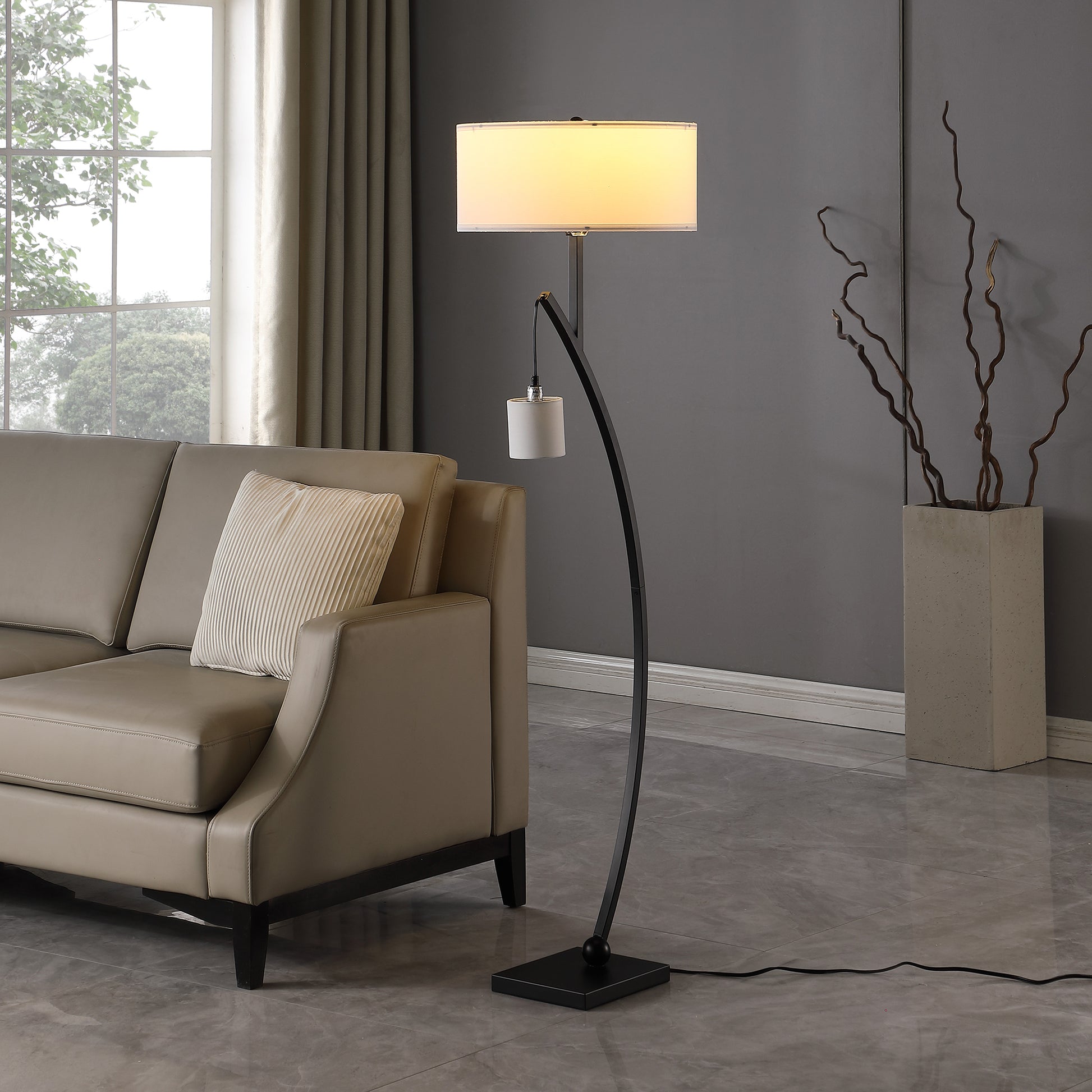 Modern arc floor lamp with cream drum shade and black metal base