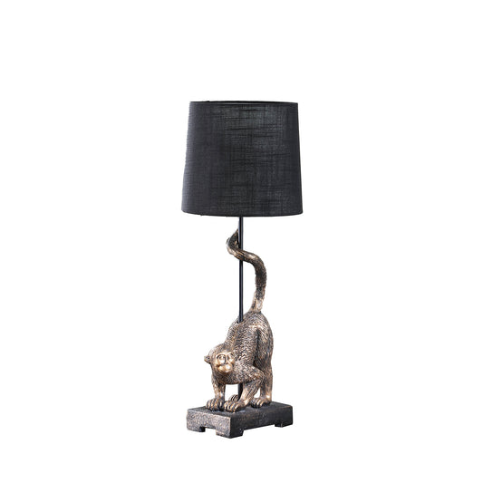 Bronze monkey table lamp with black fabric shade and antique finish