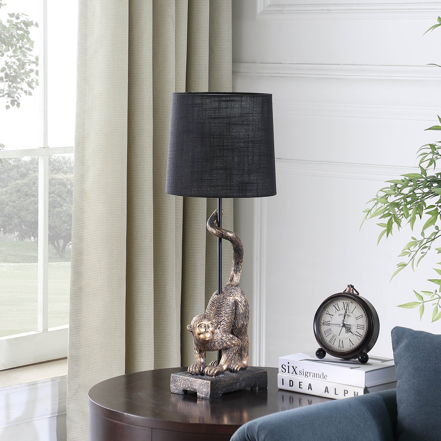 Bronze monkey table lamp with a black fabric shade adding whimsical charm to any room
