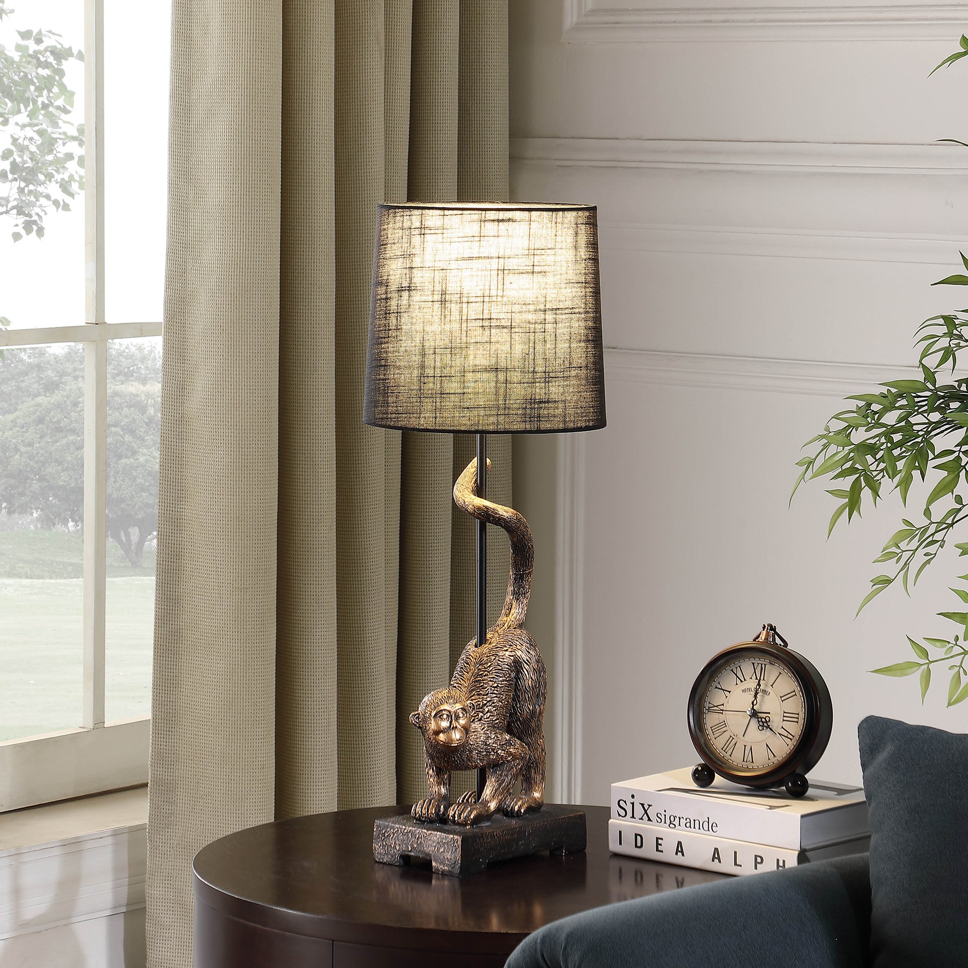 Bronze monkey table lamp with textured shade and elegant curves