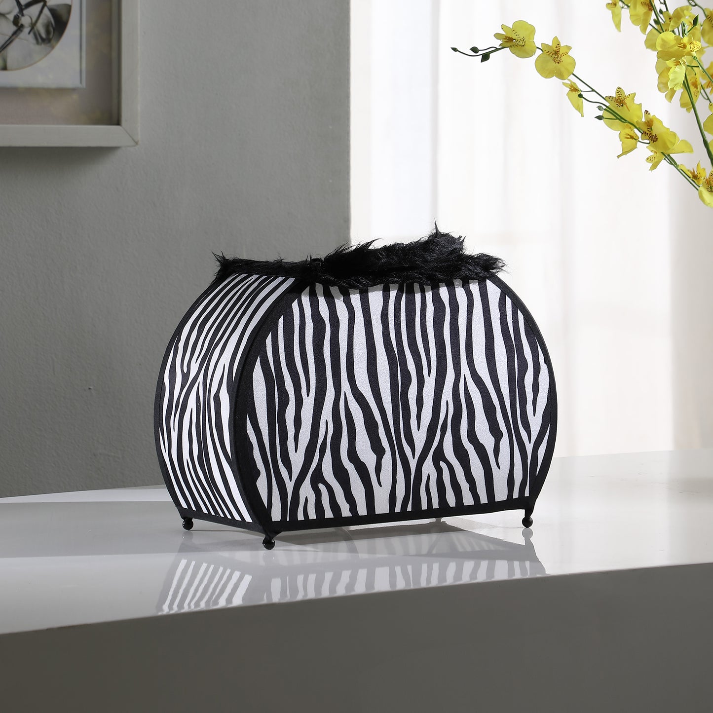 Decorative storage basket with black and white zebra print fabric and black fur trim