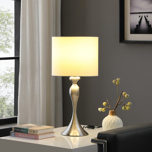 Brushed nickel table lamp with cream shade providing soft illumination for reading