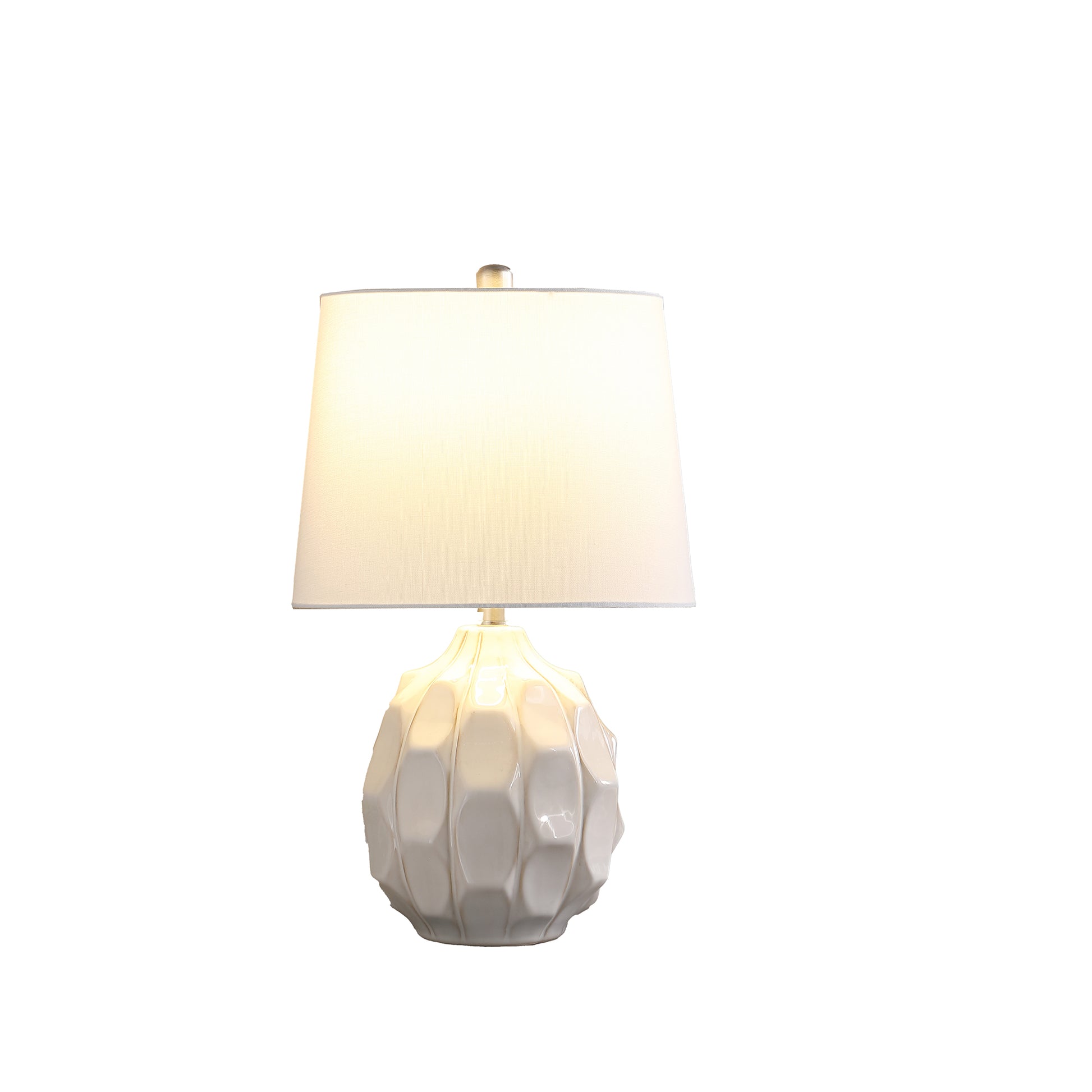 White ceramic table lamp with textured base and white linen shade