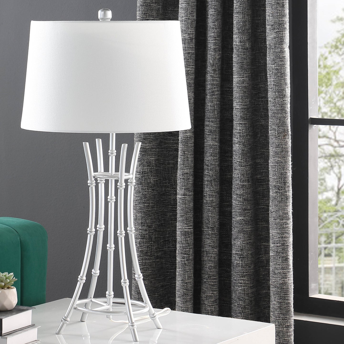 Modern white table lamp with a bambooinspired silver metal base