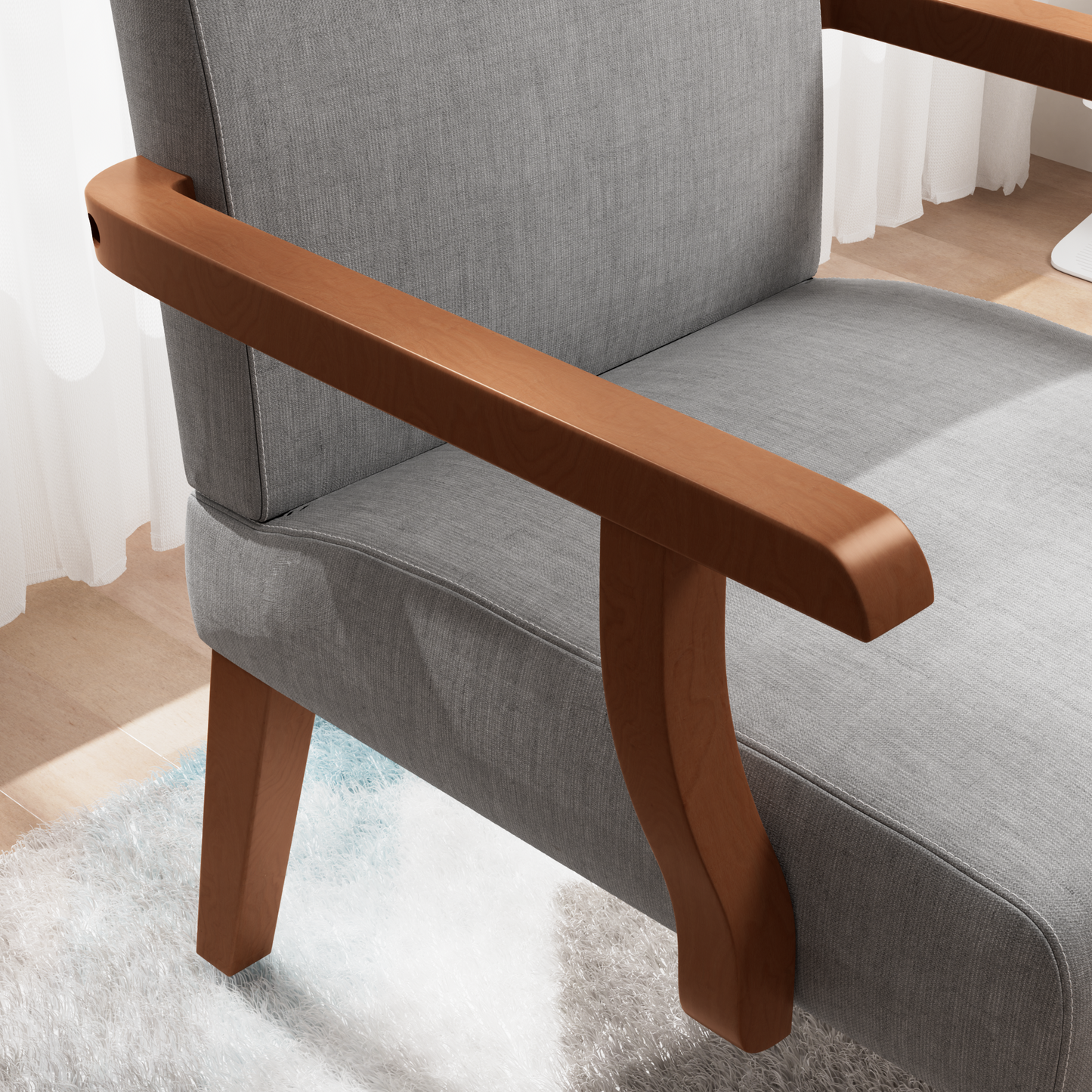 Gray fabric armchair with curved wooden armrests and legs on a fluffy rug