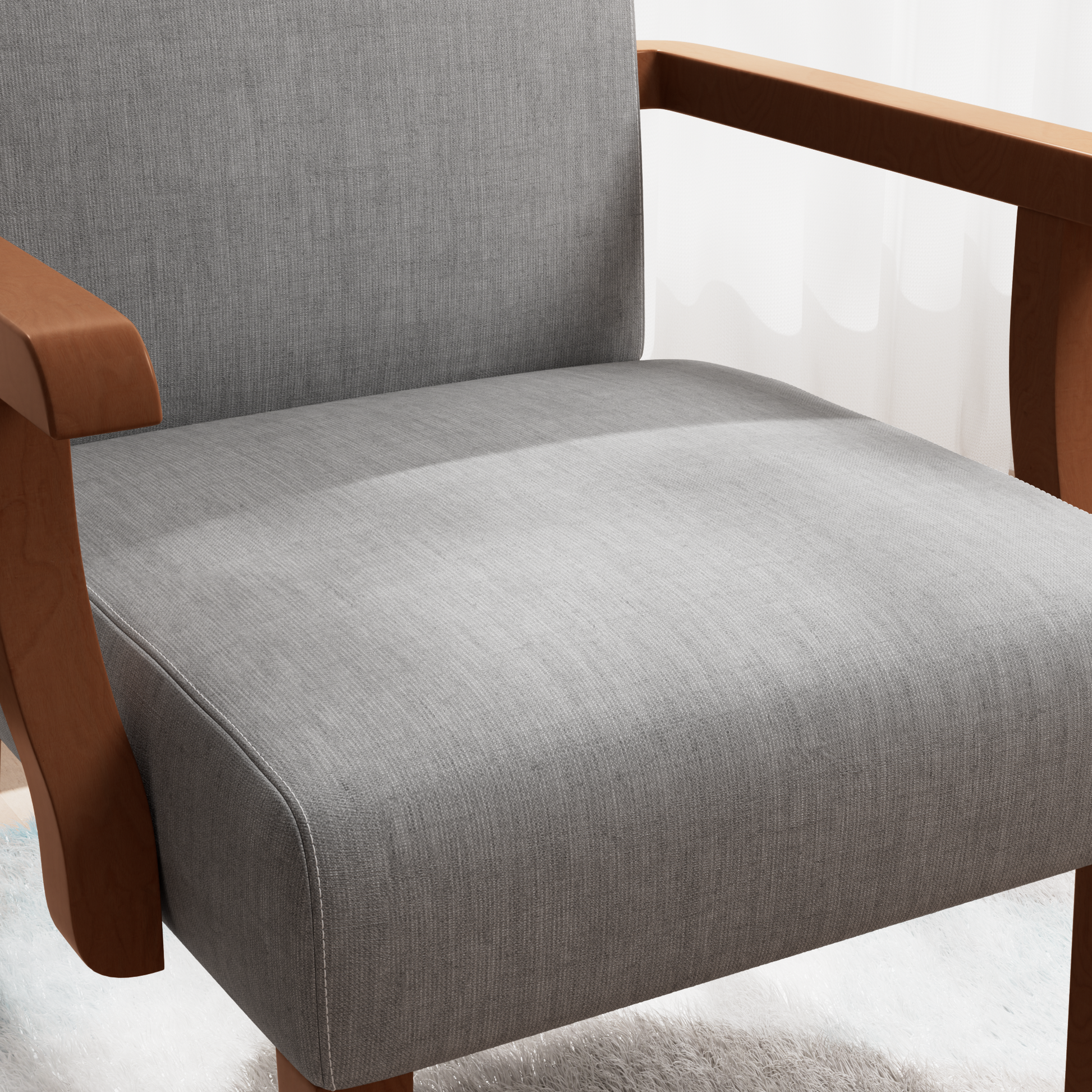 Closeup of a grey fabric accent chair with smooth wooden arms for comfortable seating