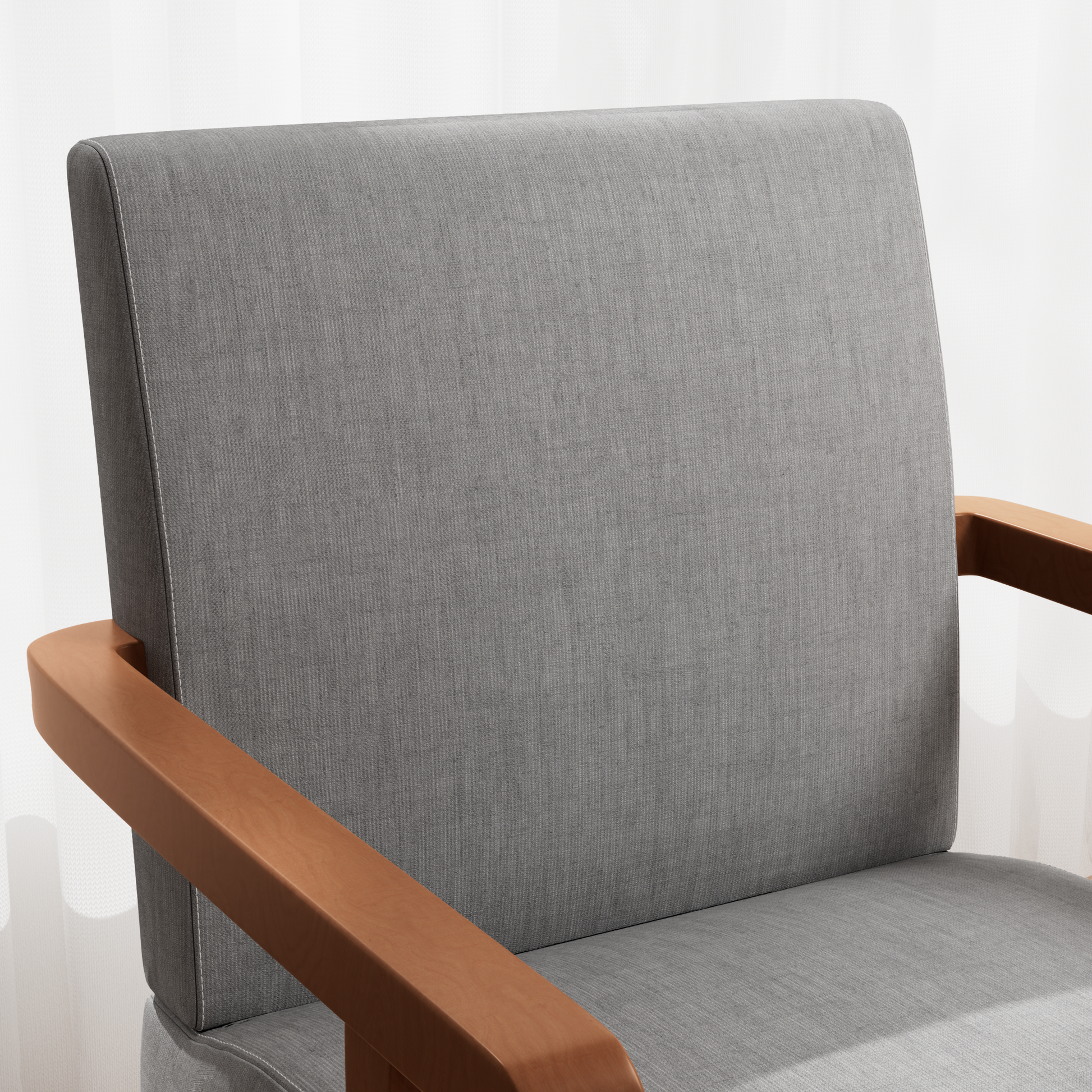 Closeup of a grey fabric armchair with smooth wooden armrests showing textured upholstery