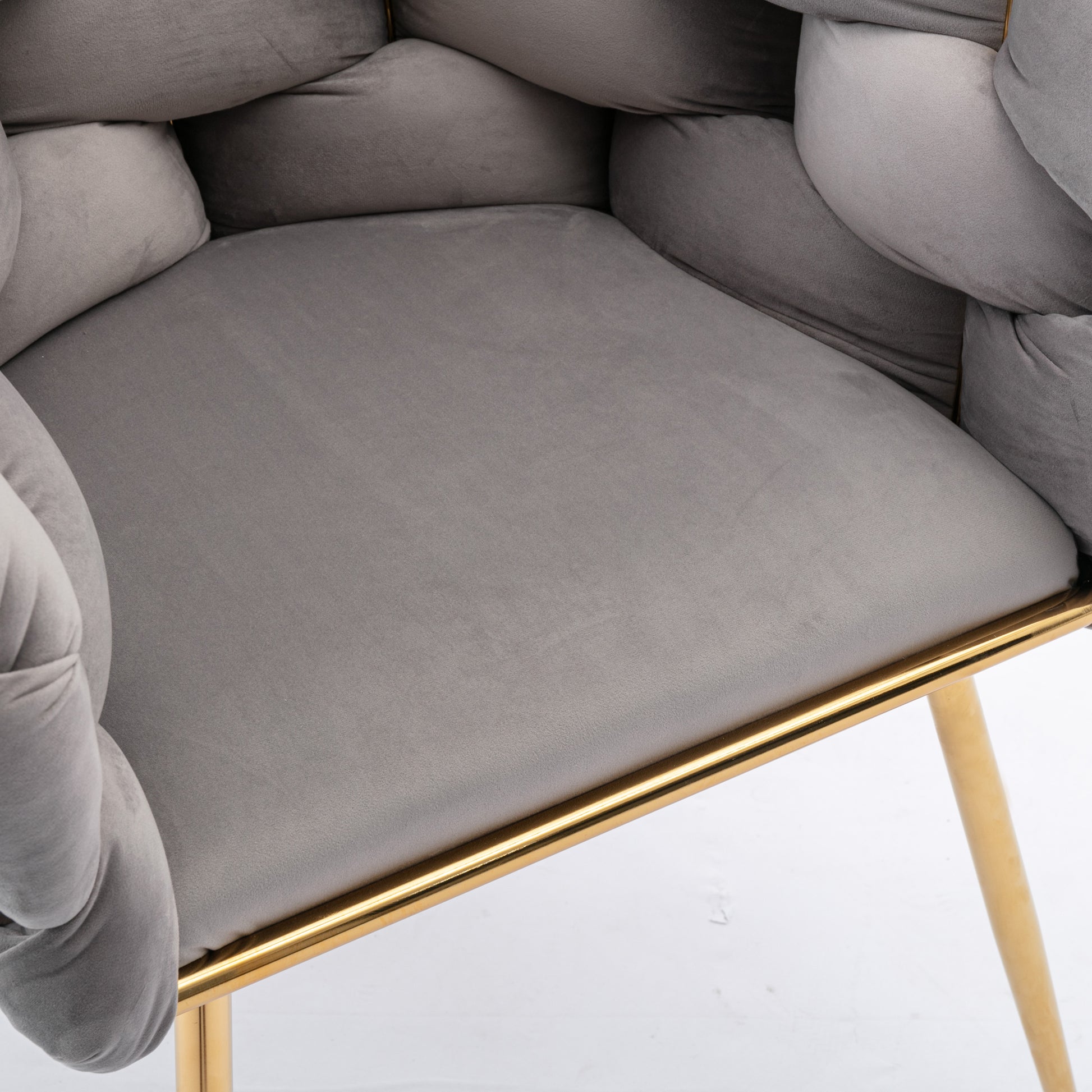 Plush grey velvet armchair with braided arms and gold metal legs perfect for accent seating