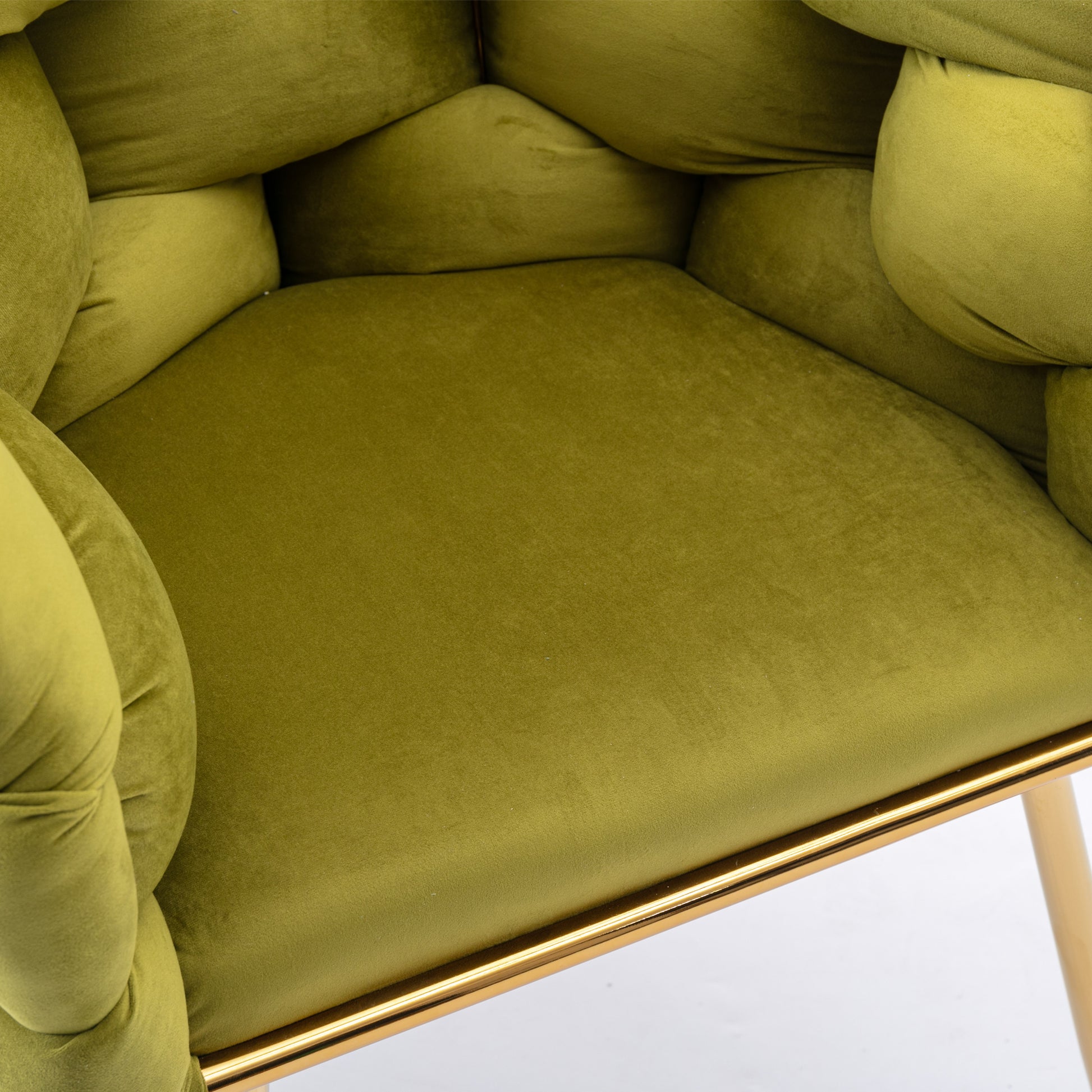 Plush green velvet armchair with button tufting and gold metal legs