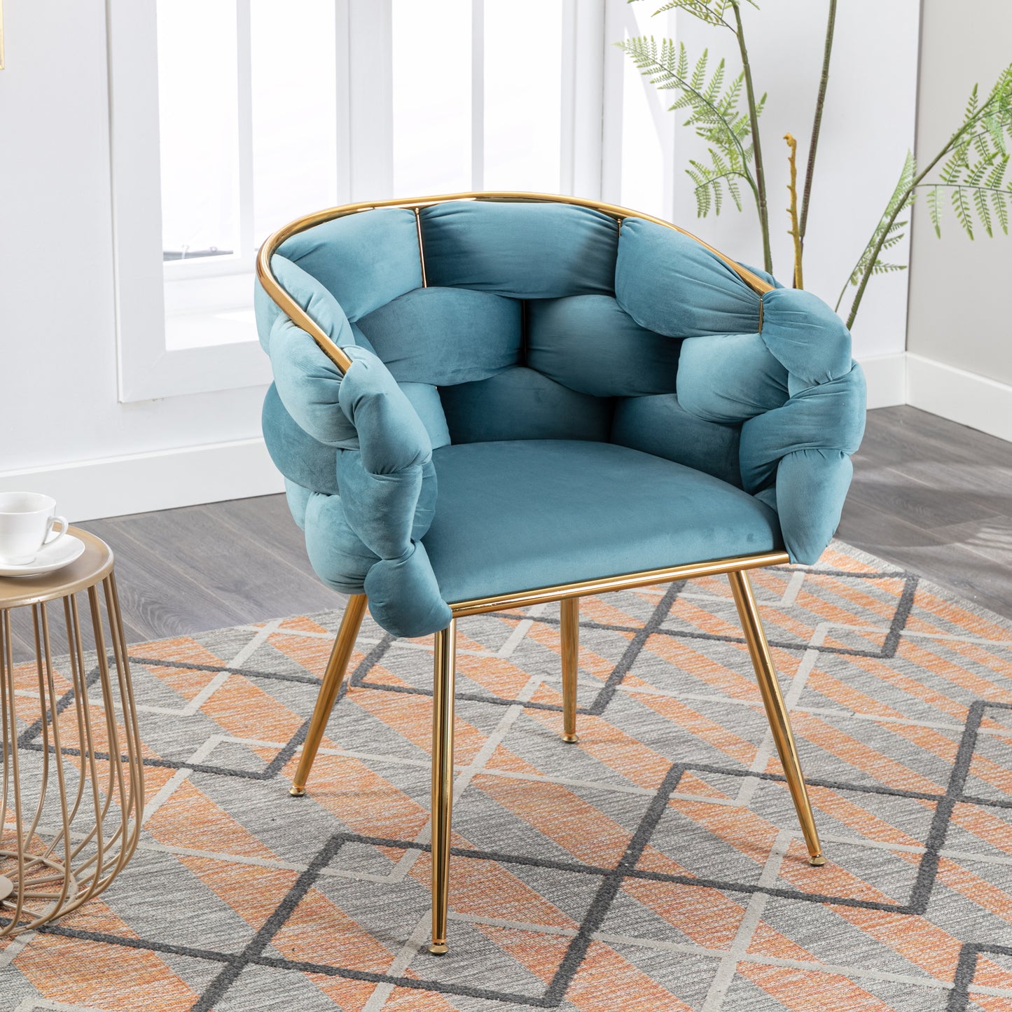 Teal velvet accent chair with unique knotted armrests and gold metal legs