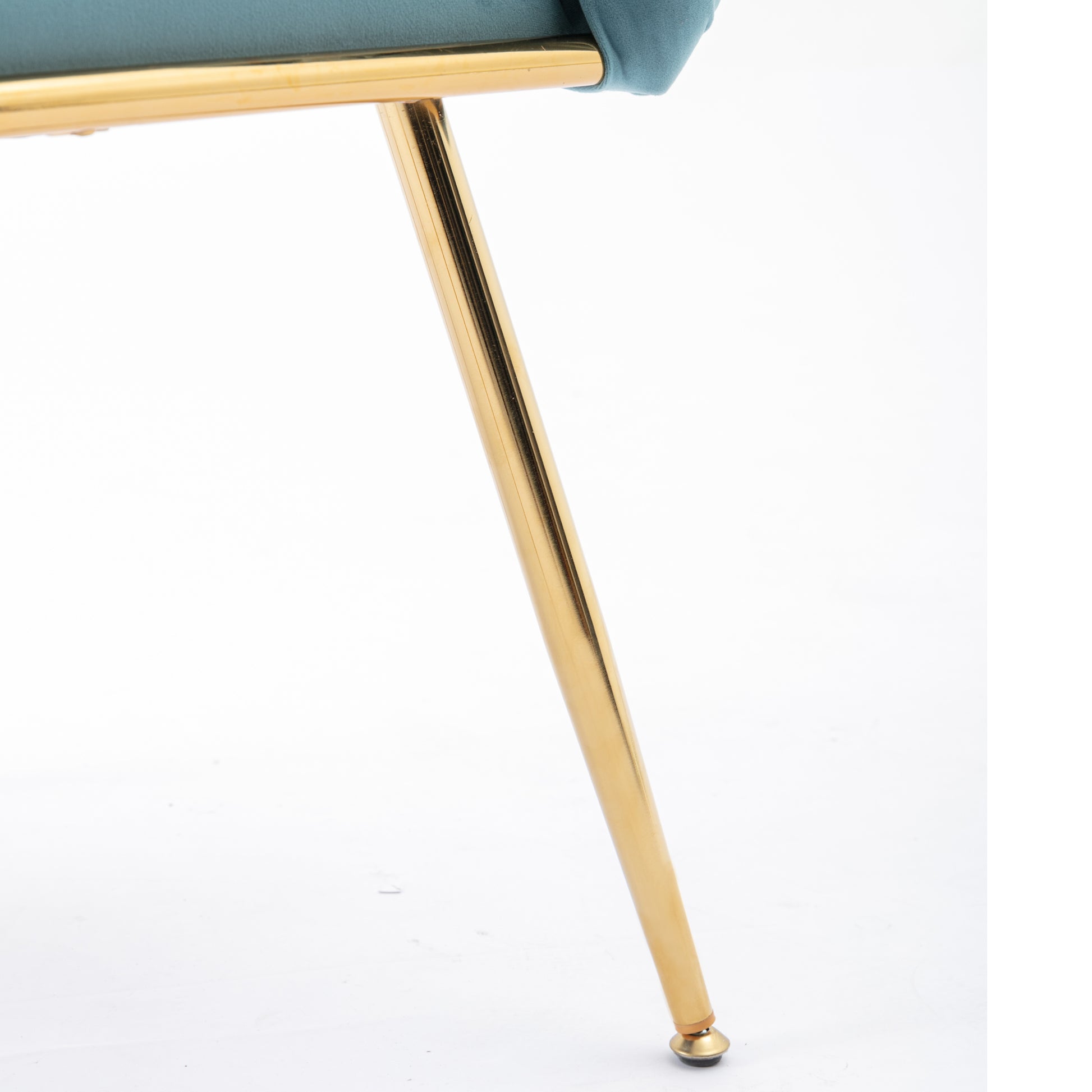 Teal velvet upholstered chair detail with slender gold metal legs
