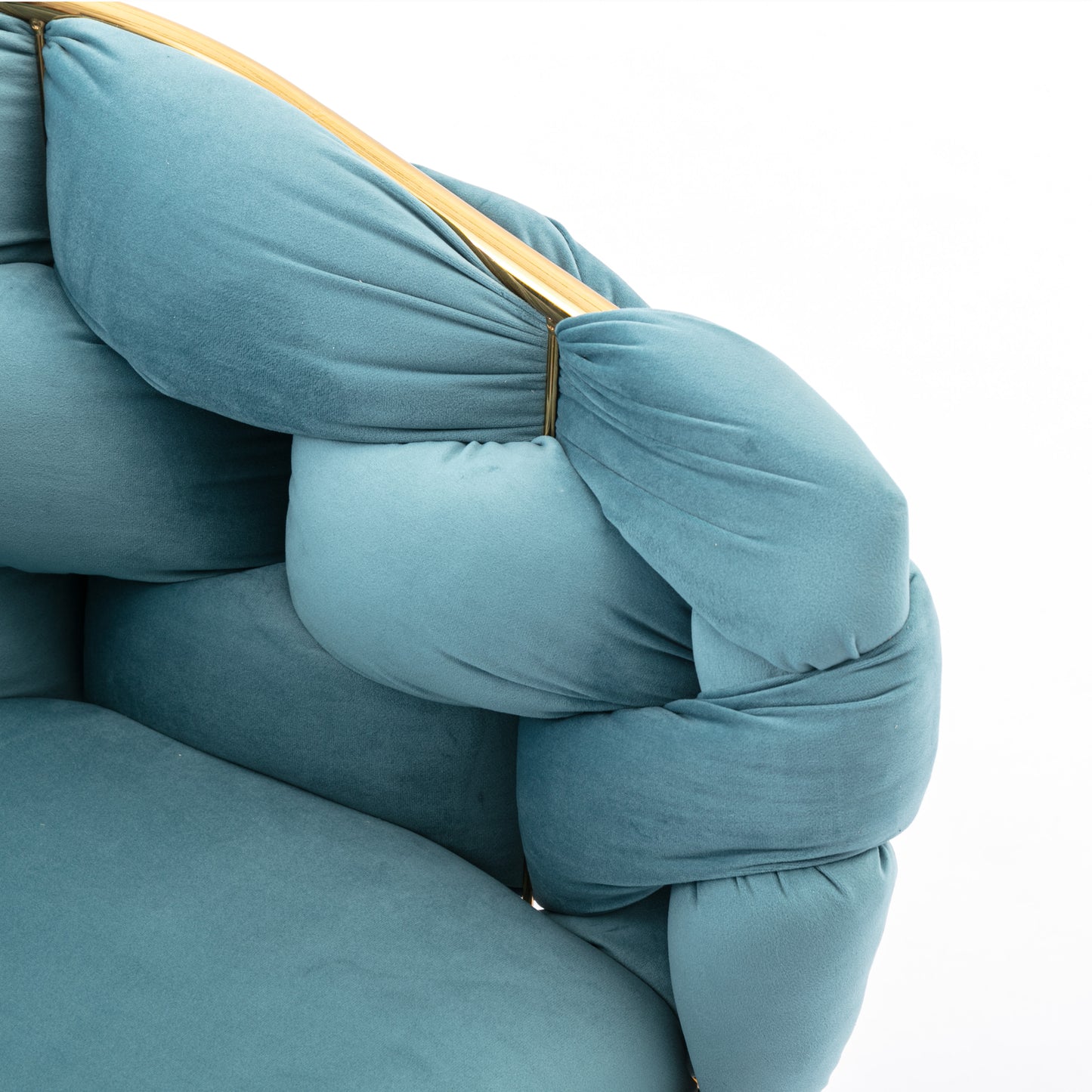 Plush teal velvet armchair with knotted armrest and gold accents