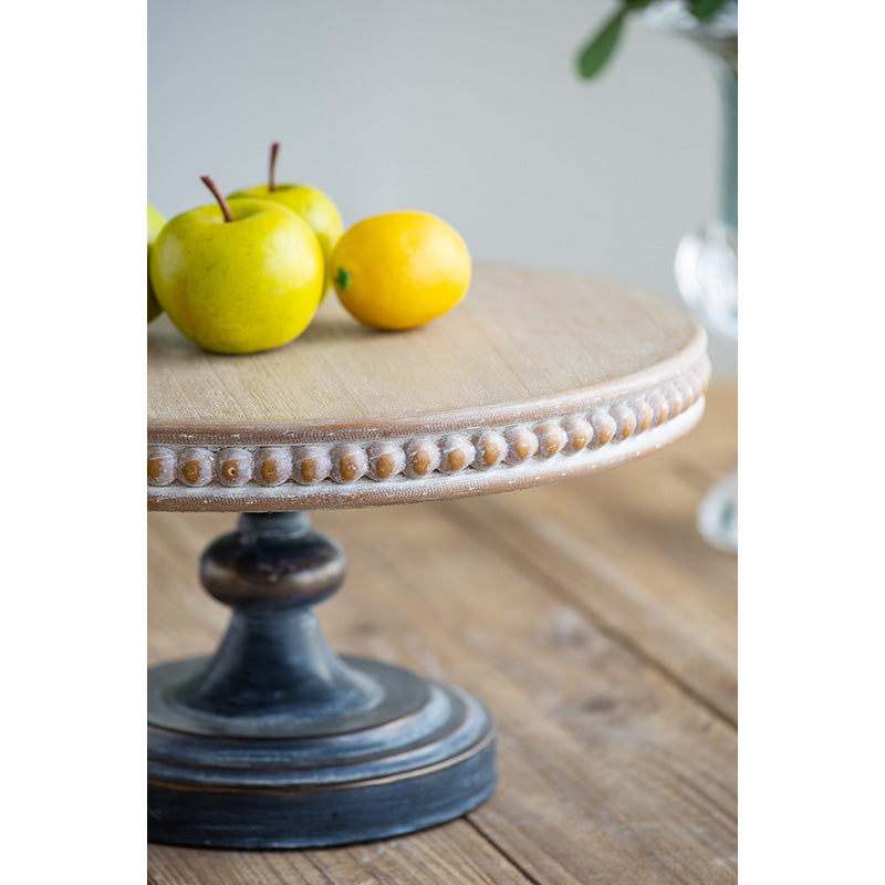Distressed wooden cake stand with beaded edge perfect for rustic farmhouse decor