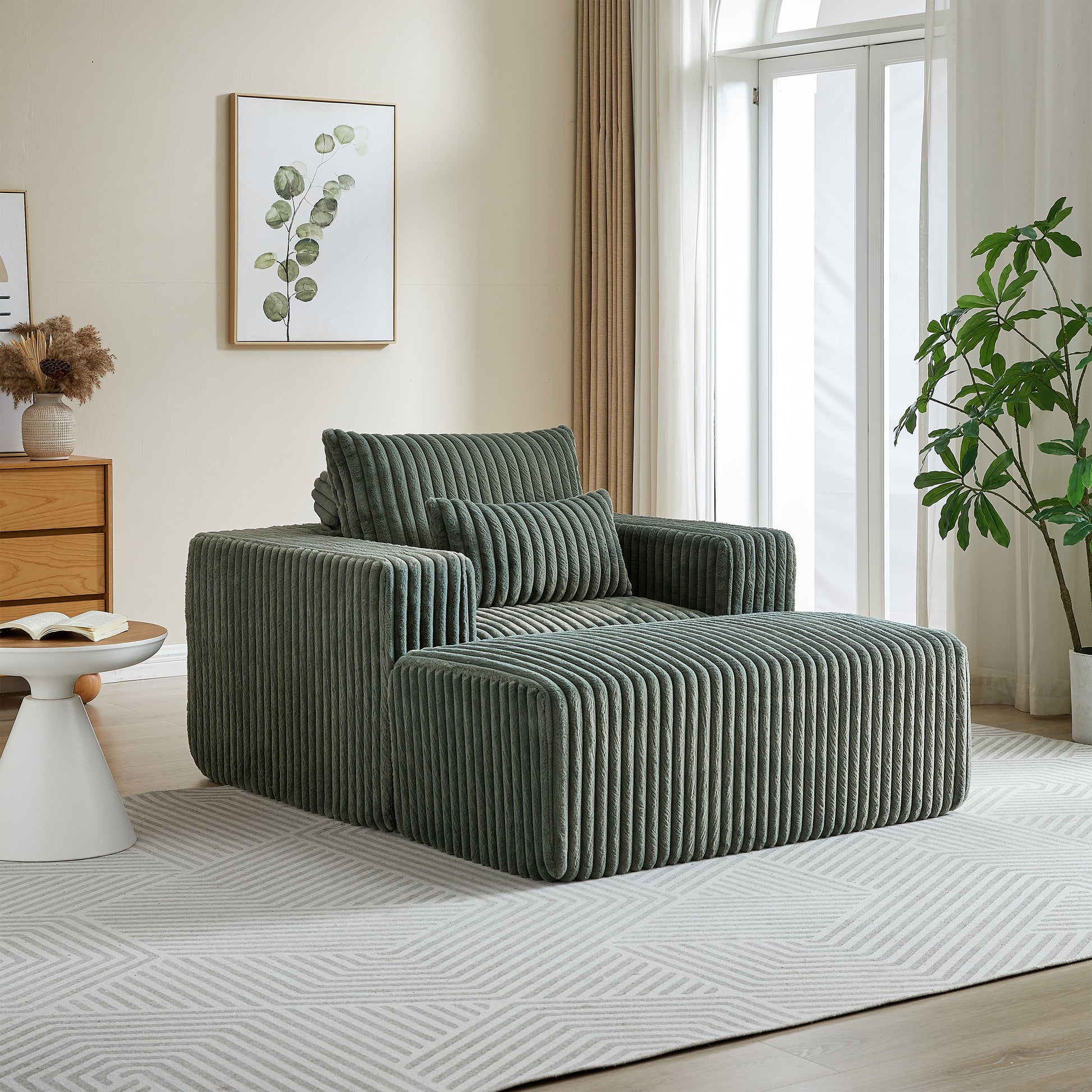 Plush corduroy armchair in sage green with matching ottoman creating a cozy seating area
