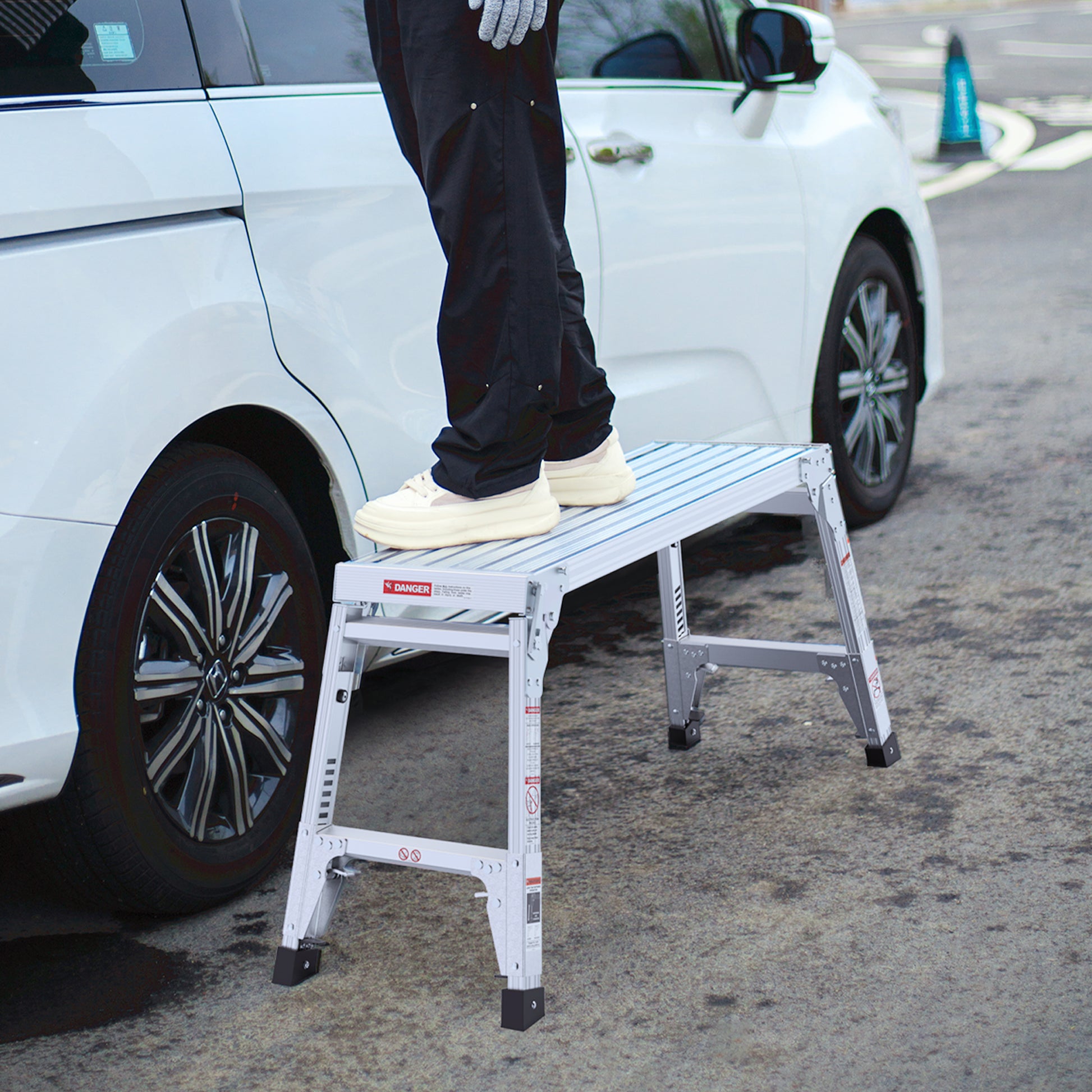 Silver aluminum folding step stool for car access featuring a nonslip ribbed platform and sturdy legs