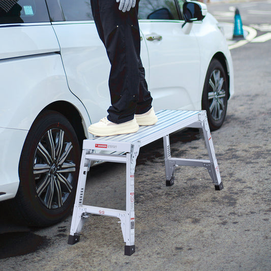 Silver aluminum folding step stool for car access featuring a nonslip ribbed platform and sturdy legs