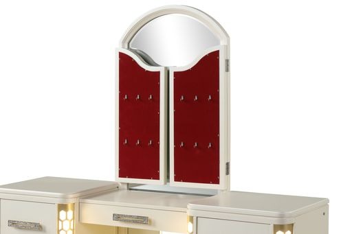 White jewelry armoire with arched mirror and red velvet doors