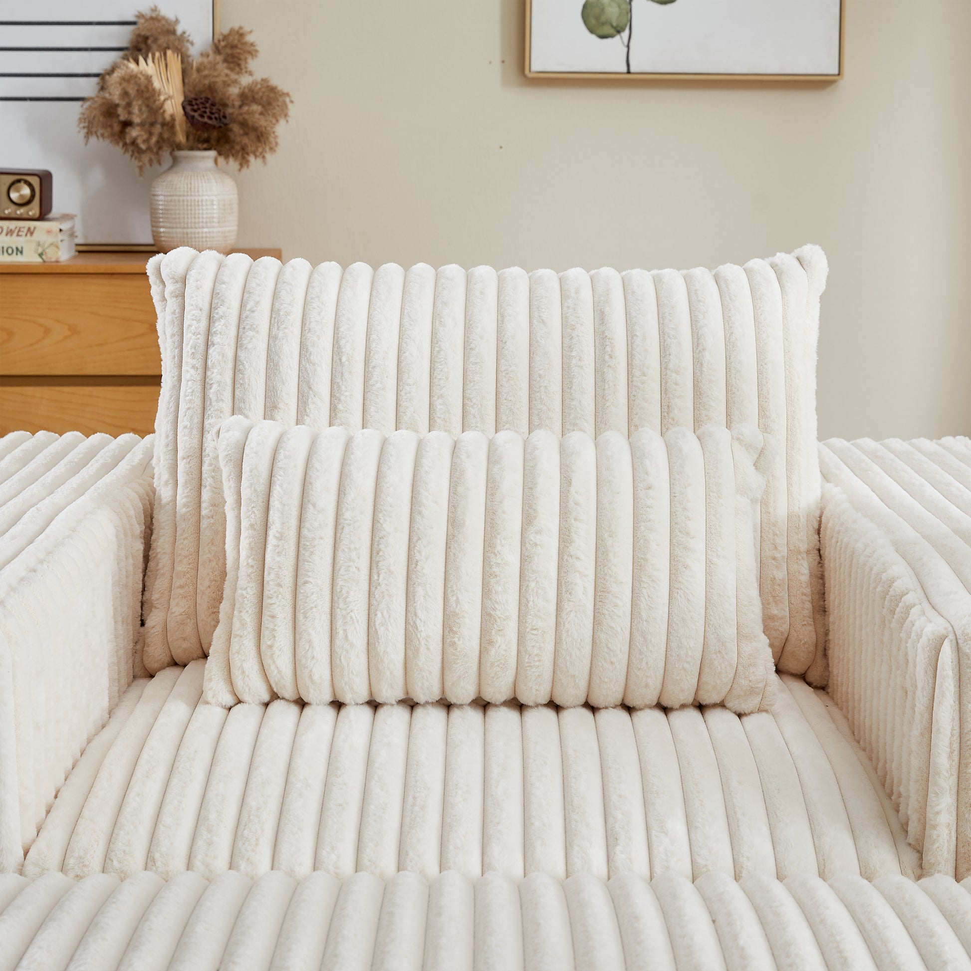 Closeup of cream corduroy plush throw pillow with ribbed texture